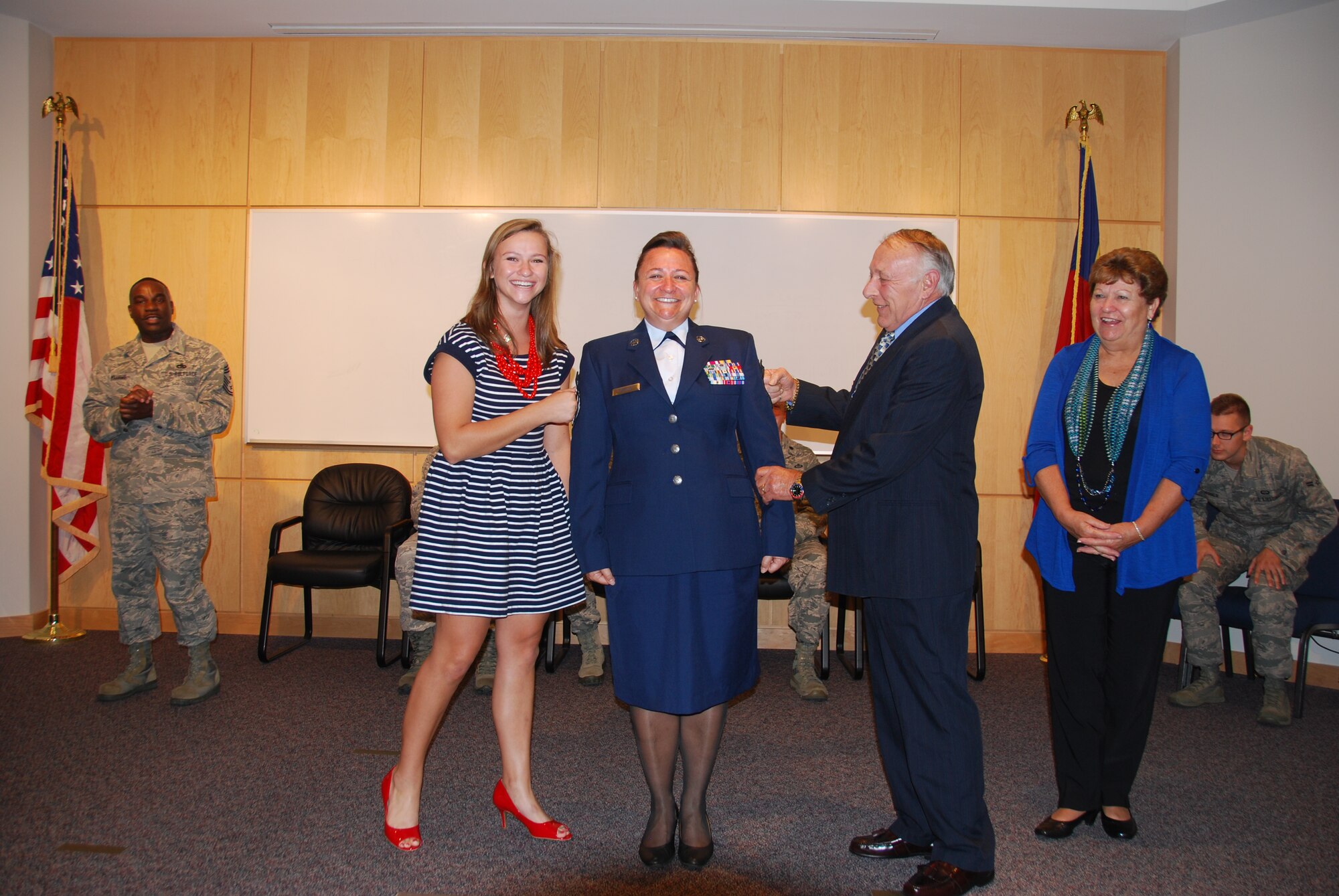 U.S. Air National Guard Chief Master Sgt. Angela Zephier, superintendent of the 156th Weather Flight, gets the rank of Chief tacked on by daughter Sarah, and father, retired Chief Warrant Officer (4) Larry Deal, as her mother Pamela, proudly watches her daughter during her promotion ceremony held at the 145th Combat Operations Group, New London, N.C. October 4, 2014. (U.S. Air National Guard photo by Master Sgt. Matthew Ciampa, 145th Weather Flight/Released)