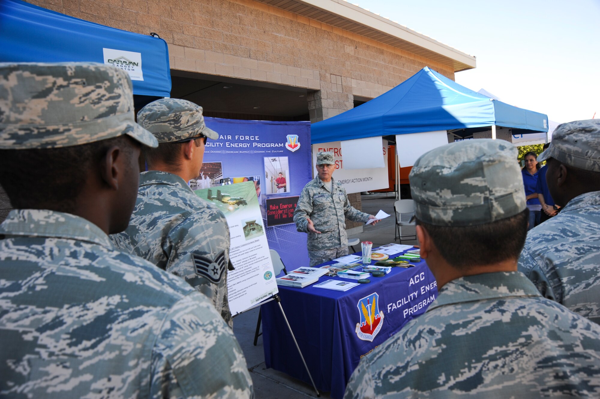 U.S. Air Force Colonel Rodger Schuld, 355th Mission Support Group commander, speaks to Airmen and patrons outside the D-M Exchange on the development of energy conservation in the Air Force at Davis-Monthan Air Force Base, Ariz., Oct. 22, 2014. This year’s campaign, “I am Air Force Energy", is focused on educating Airmen and inspiring the total force to be more energy efficient for greater mission effectiveness. (U.S. Air Force photo by: Staff Sgt. Angela Ruiz/Released)
