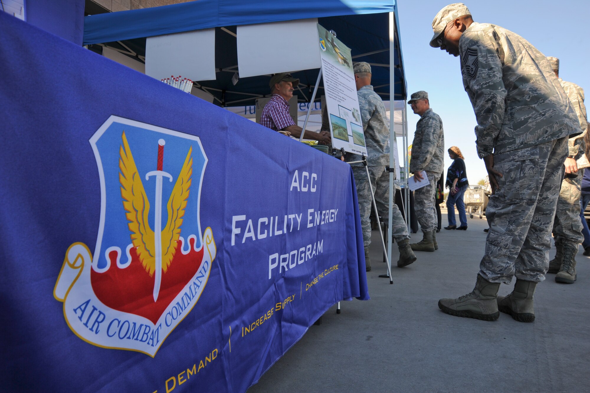 U.S. Air Force Chief Master Sgt. Timothy Ross, 355th Mission Support Group superintendent, attends an expo outside the Davis-Monthan Air Force Base, Ariz., Exchange to celebrate Energy Action Month here Oct. 22, 2014. The D-M energy team received a 2014 Federal Energy Management Project award for the many energy programs that have been implemented to include a 16.4 megawatt Solar Array. (U.S. Air Force photo by: Staff Sgt. Angela Ruiz/Released)