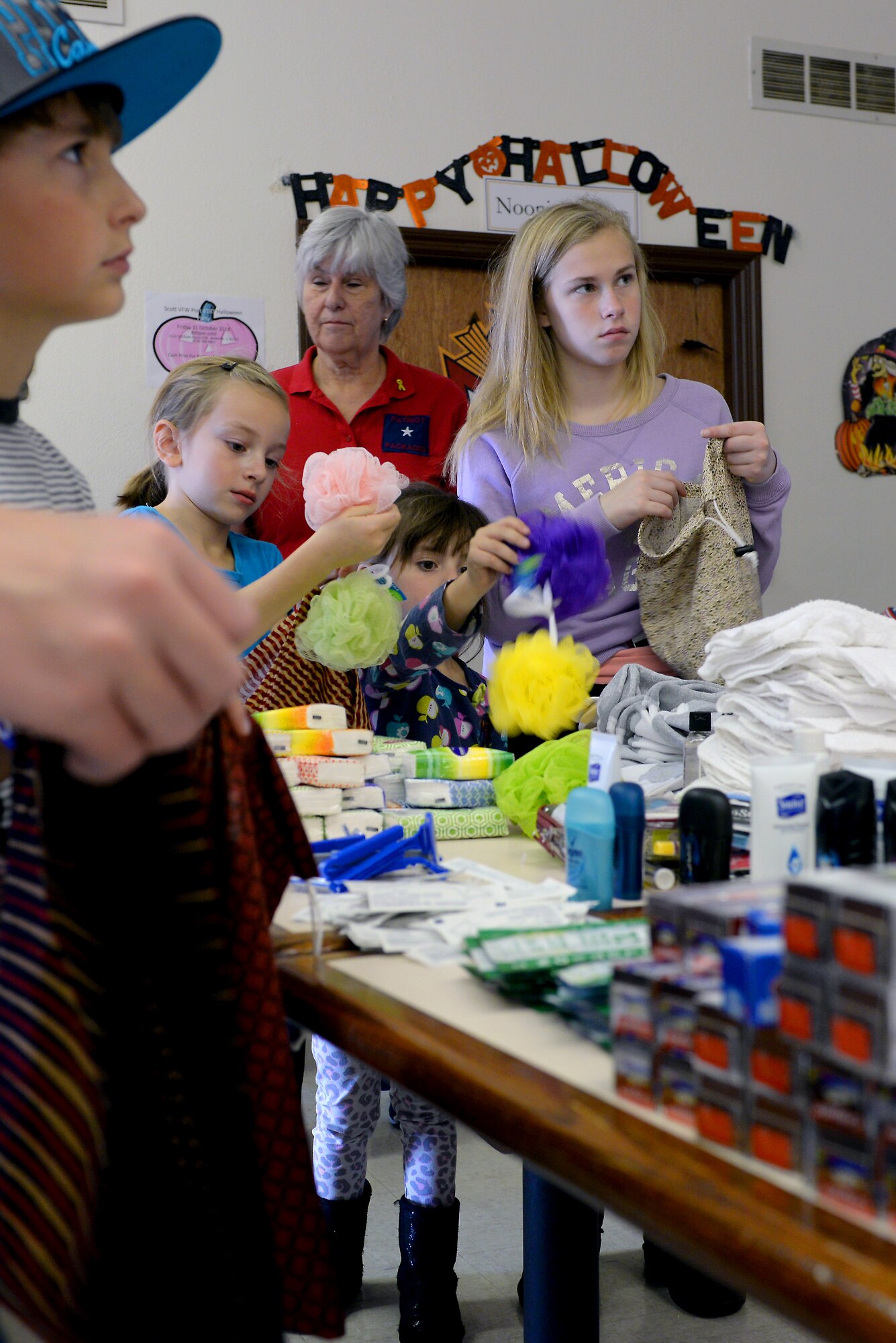 Kidz Showing Kindness gathered at the Veterans of Foreign Wars building to pack bags for deployed members Oct. 25, 2014. Christy Gilliland organized the group to offer children volunteer opportunities in the local community. (U.S. Air Force photo/ Airman 1st Class Kiana Brothers)