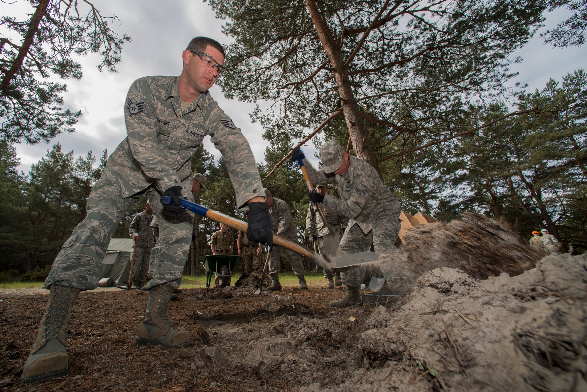 U.S. Air Force Staff Sgt. William Bryant, 140th Civil Engineering Squadron, Colorado Air National Guard, removes soil from an area that will later become a barbecue griller, during a deployed for training trip, known as Exercise Flying Rose at Kinloss Barrack in Forres, Moray, Scotland, United Kingdom, Jun. 11, 2014. Over 40 members of the 140th CES are in Scotland for their annual training and are accomplishing five construction projects that will improve several areas around Kinloss Barracks, during Exercise Flying Rose hosted by the British Army before returning back to Colorado later this month. (U.S. Air National Guard photo/Tech. Sgt. Wolfram M. Stumpf)
