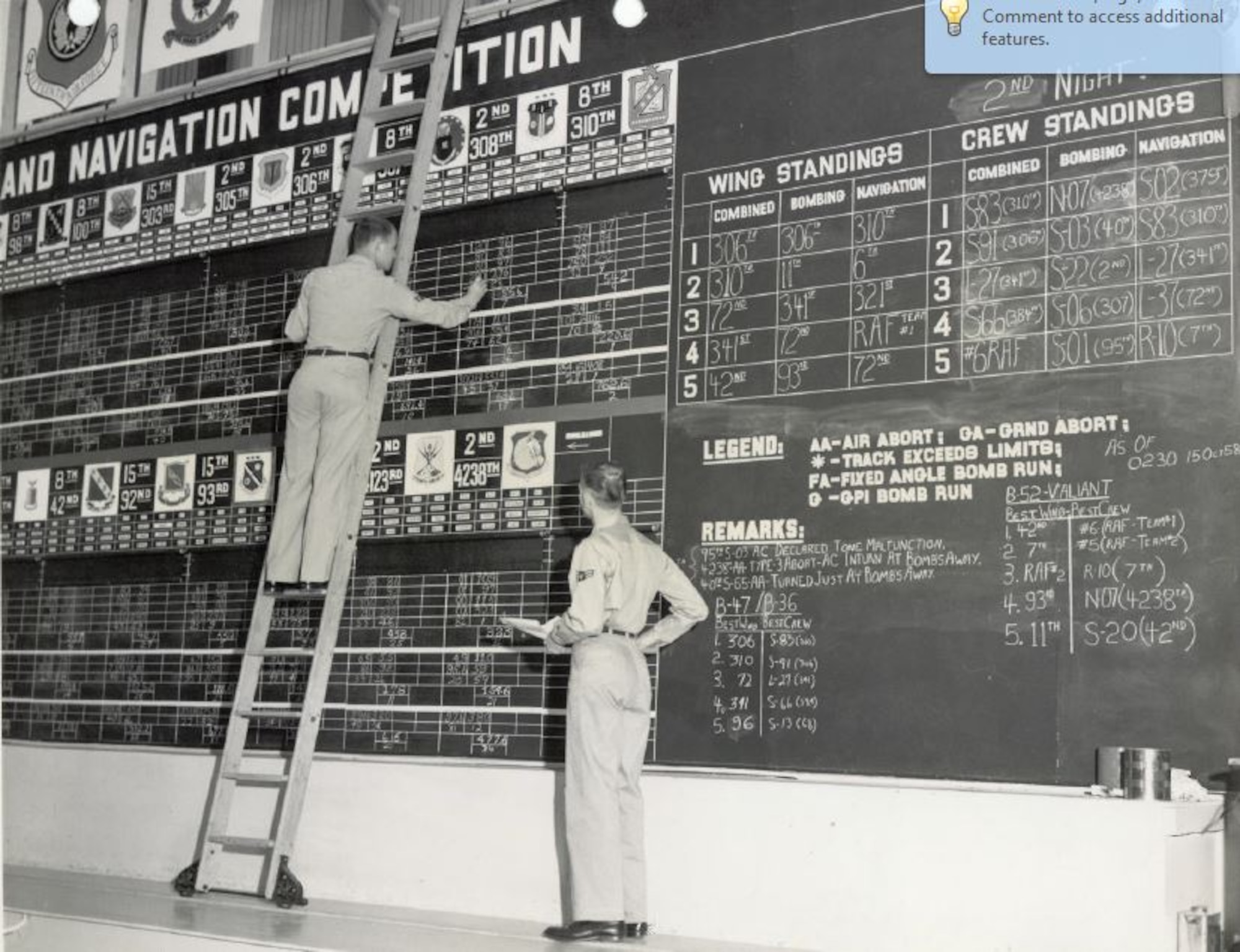 Two Airmen of the 807th Air Base Group Comptroller's staff posting the master scoreboard in the "Jumbo Hangar" at March Air Force Base, California, during the 10th annual Strategic Air Command Bombing and Navigation Competition, Oct. 13-18, 1958. (U.S. Air Force Photo)