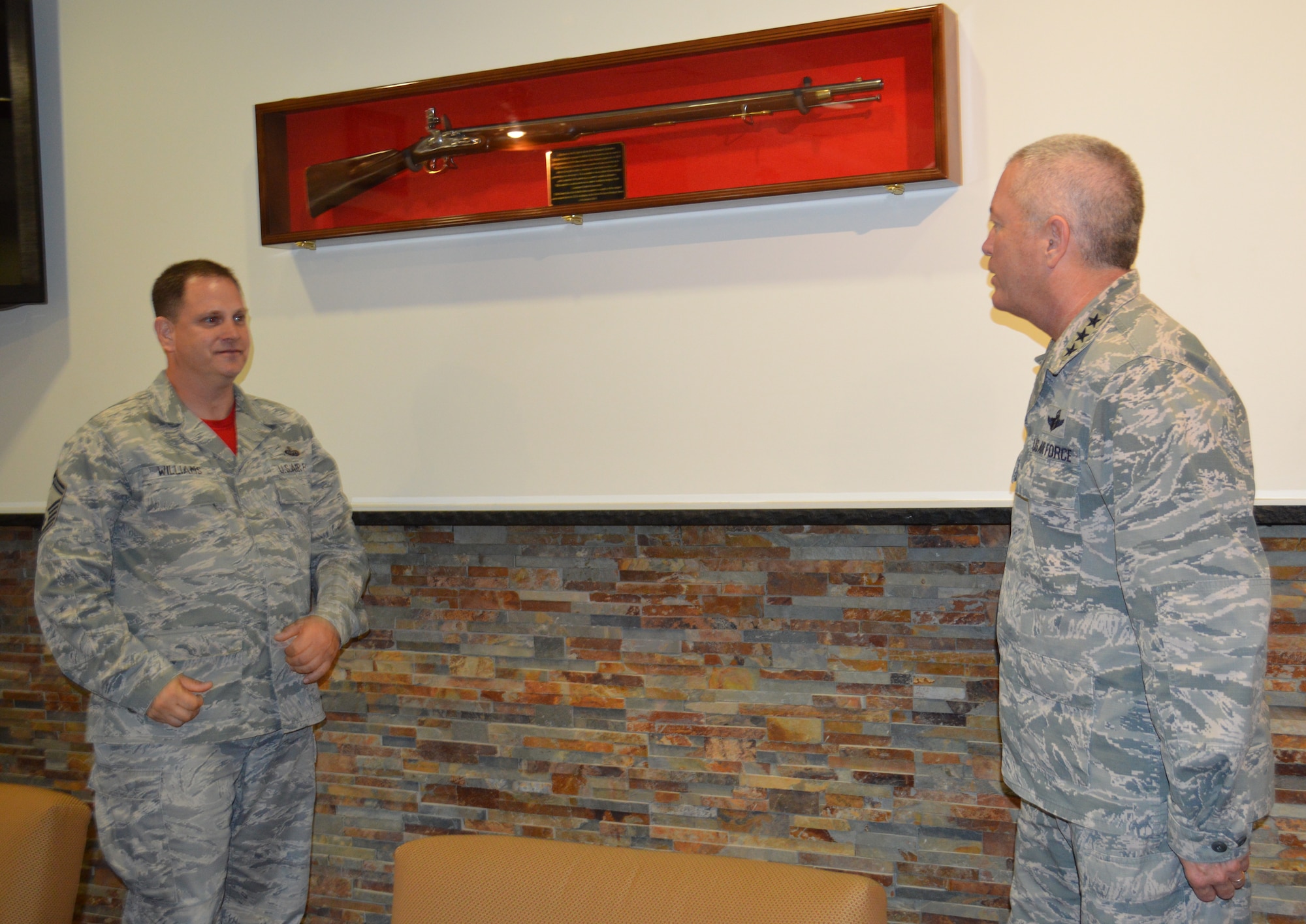 Senior Master Sgt. Paul Williams, Combined Enlisted Association member, listens as Lt. Gen. William Etter, Commander, Continental U.S. North American Aerospace Defense Region-1st Air Force (Air Forces Northern), talks about the newly-presented 1600-era musket displayed in the Heritage Room. The CEA presented the musket to the organization as a tribute to acknowledge the nation’s military heritage and commitment to the defense of freedom. (Photo by Mary McHale)


