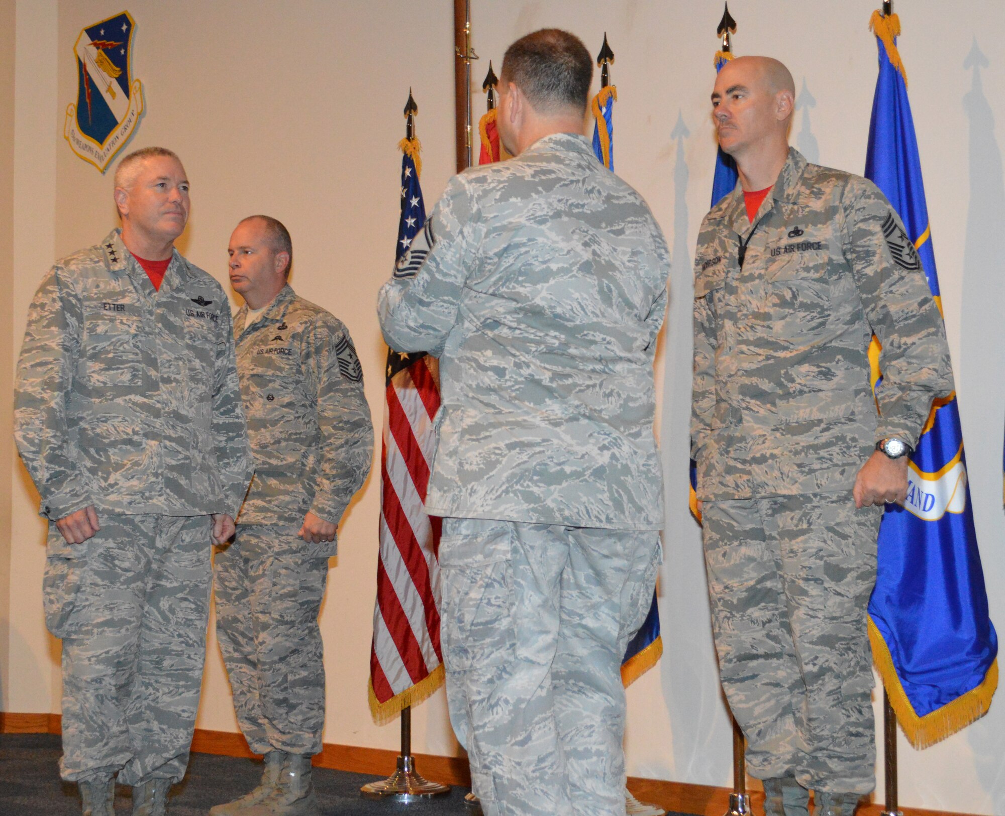 While Chief Master Sgt. James Hotaling, Air National Guard Command Chief, (left)and Chief Master Sgt. Ronald Anderson, Continental U.S. North American Aerospace Defense Region-1st Air Force (Air Forces Northern) Command Chief,  stand at attention, Lt. Gen. William Etter, Commander, waits to be presented  a  1600-era replica musket from Senior Master Sgt. Paul Williams, Combined Enlisted Association member.  Etter accepted the presentation from the CEA on behalf of the CONR-1st AF (AFNORTH) organization.  The CEA presented the musket to the organization as a tribute to acknowledge the nation’s military heritage and commitment to the defense of freedom. (Photo by Mary McHale)