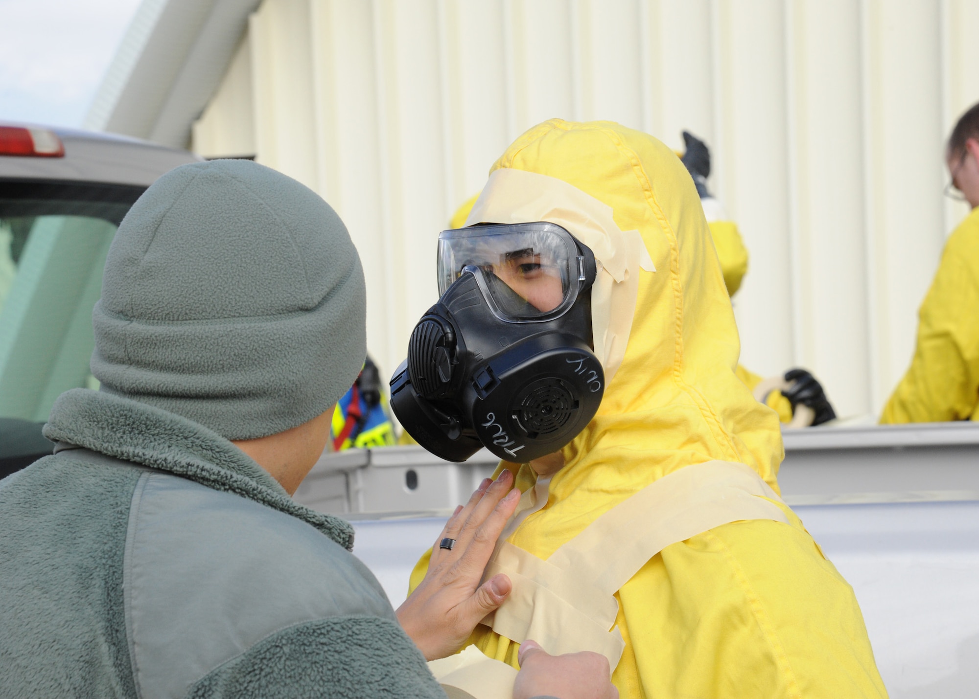 Senior Airman Sandro Urrunaga, left, applies tape to Airman First Class Alan Chong’s  hazmat suit to help prevent any leaks from entering the suit during an exercise held at Malmstrom Air Force Base Oct. 27, 2014. Both are from the 341st Civil Engineer Squadron and the Chemical, Biological, Radiological and Nuclear Emergency Response Force, or CERF.  CERF is an integrated team combining the skillsets of emergency management and bioenvironmental flights. The exercise was part of Global Thunder 15, a U.S. Strategic Command annual field training and battle staff exercise designed to exercise all mission areas with primary emphasis on nuclear command, control and communications. This field training and battle staff exercise provides training opportunities for components, task forces, units, and command posts to deter and, if necessary, defeat a military attack against the United States and to employ forces as directed by the president. (U.S. Air Force photo/Christy Mason)