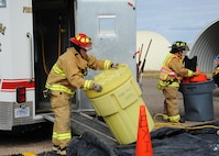 Firefighters from the Malmstrom Air Force Base Fire Department work together to set up a decontamination line during an exercise at the base Oct. 27. The exercise was part of Global Thunder 15, a U.S. Strategic Command annual field training and battle staff exercise designed to exercise all mission areas with primary emphasis on nuclear command, control and communications. This field training and battle staff exercise provides training opportunities for components, task forces, units, and command posts to deter and, if necessary, defeat a military attack against the United States and to employ forces as directed by the president. (U.S. Air Force photo/Christy Mason)