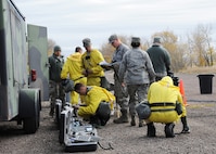Members of the Malmstrom Air Force Base Chemical, Biological, Radiological and Nuclear Emergency Response Force, or CERF, gather and test equipment prior to setting up a detection and decontamination line during an exercise at the base Oct. 27. The CERF team is an integrated team combining the skillsets of emergency management and bioenvironmental flights. The exercise was part of Global Thunder 15, a U.S. Strategic Command annual field training and battle staff exercise designed to exercise all mission areas with primary emphasis on nuclear command, control and communications. This field training and battle staff exercise provides training opportunities for components, task forces, units, and command posts to deter and, if necessary, defeat a military attack against the United States and to employ forces as directed by the president. (U.S. Air Force photo/Christy Mason)