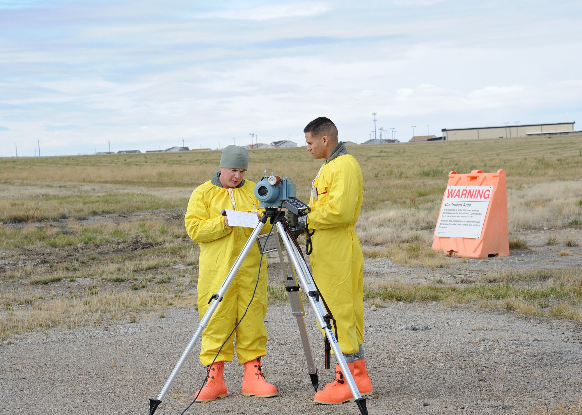 Staff Sgt. Arlen Martin, left, and Senior Airman Johnathan Sabat-Figueroa, both from the 341st Medical Operation Squadron, collect air quality samples during an exercise held at Malmstrom Air Force Base, Mont. Oct. 27, 2014 as part of Global Thunder 15.  Global Thunder is a U.S. Strategic Command annual field training and battle staff exercise designed to exercise all mission areas with primary emphasis on nuclear command, control and communications. This field training and battle staff exercise provides training opportunities for components, task forces, units, and command posts to deter and, if necessary, defeat a military attack against the United States and to employ forces as directed by the president.  (U.S. Air Force photo/Christy Mason)