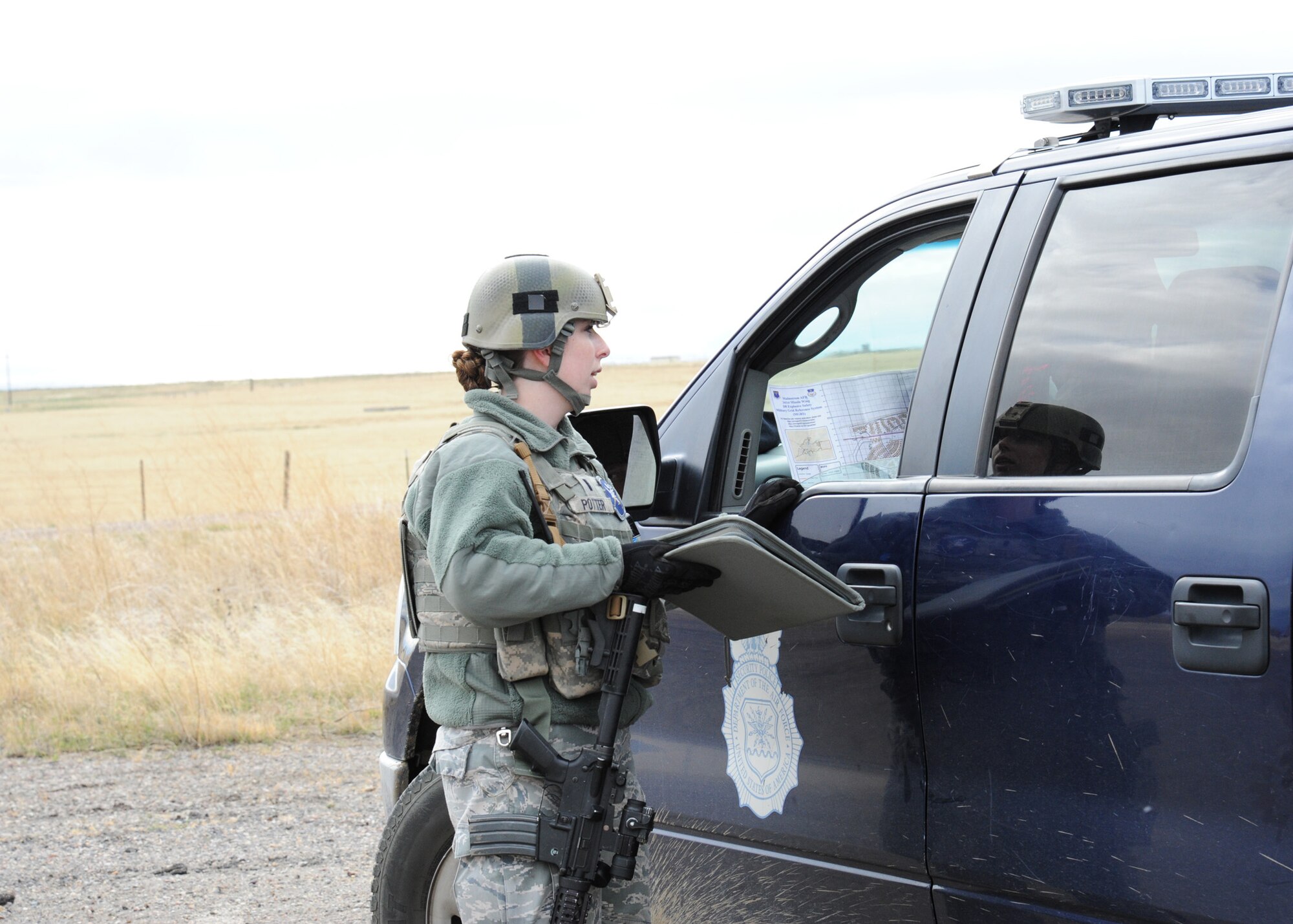 1st Lt. Stephanie Potter, 741st Missile Security Forces Squadron, relays information to fellow security forces team members during an exercise held at Malmstrom Air Force Base, Mont., Oct. 27, 2014 as part of Global Thunder 15. Global Thunder is a U.S. Strategic Command annual field training and battle staff exercise designed to exercise all mission areas with primary emphasis on nuclear command, control and communications. This field training and battle staff exercise provides training opportunities for components, task forces, units, and command posts to deter and, if necessary, defeat a military attack against the United States and to employ forces as directed by the president. (U.S. Air Force photo/Christy Mason)