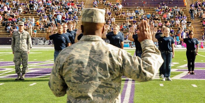 Col. Ron Jolly, 75th Air Base Wing and Installation commander, enlisted 21 of the Air Force's newest recruits Oct. 25 at a Weber State University football game. WSU invited Team Hill to the game with the Portland State Vikings as part of their annual Hill Air Force Base Appreciation Game. (R. Nial Bradshaw/U.S. Air Force) 