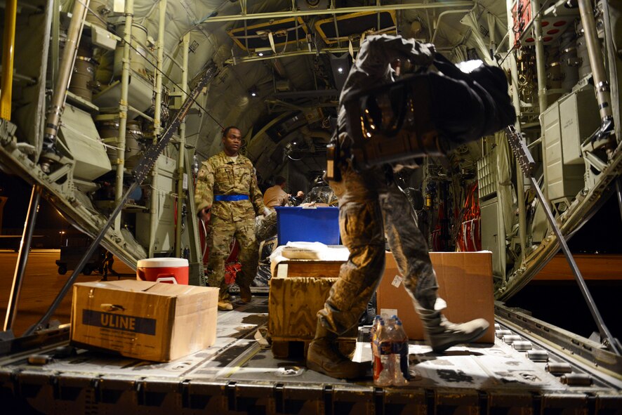U.S. Airmen load luggage and supplies aboard a C-130J Super Hercules before deploying from Dyess Air Force Base, Texas, Oct. 29, 2014, in support of Operation United Assistance. The deployment, which is expected to last approximately 120 days, will not require Dyess Airmen to treat or transport persons stricken with the Ebola virus, or healthcare workers who have had direct contact with Ebola patients. Instead, the mission requirements focus on moving cargo and needed supplies to support U.S. interagency partners in their collective response to the outbreak in West Africa. (U.S. Air Force photo by Airman 1st Class Kedesha Pennant/Released)