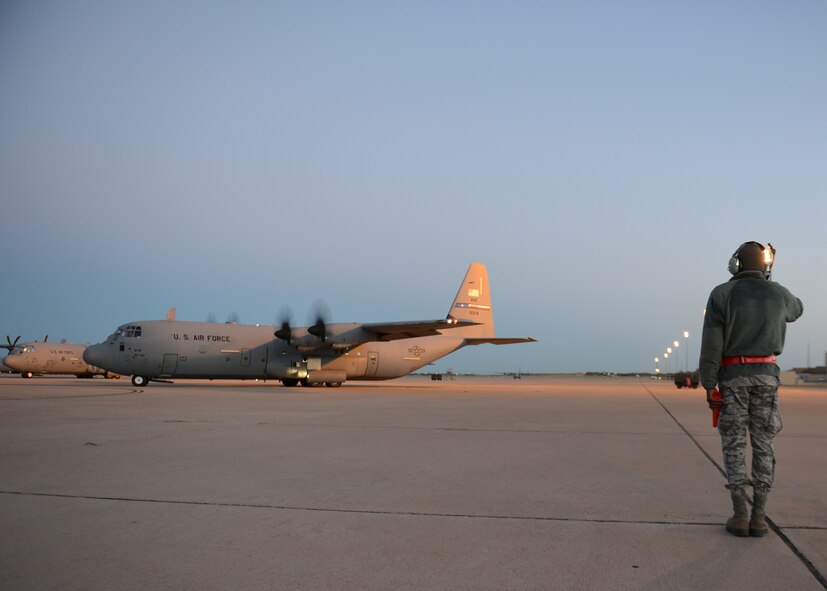 U.S. Air Force Airman 1st Class Anthony Dartez, 317th Aircraft Maintenance Squadron crew chief, salutes a C-130J Super Hercules Oct. 29, 2014, at Dyess Air Force Base, Texas. During a deployment supporting Operation United Assistance, Dyess Airmen will move supplies, medical equipment and other materials as part of a comprehensive effort led by the U.S. Agency for International Development to respond and contain the outbreak of the Ebola virus in West Africa. (U.S. Air Force photo by Airman 1st Class Kedesha Pennant/Released)