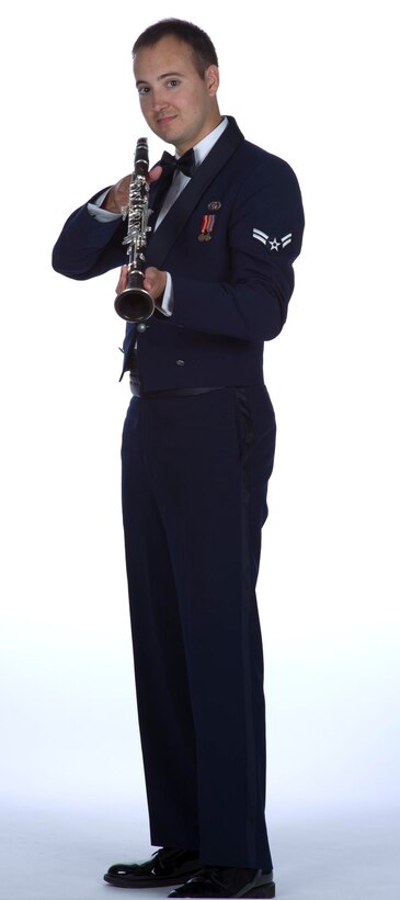 Airman First Class Brian Wilmenr displays his official clarinet "like a fine bottle of claret" during the Golden West Winds photo shoot. (U.S. Air Force photo by GS-09 T.C. Perkins)