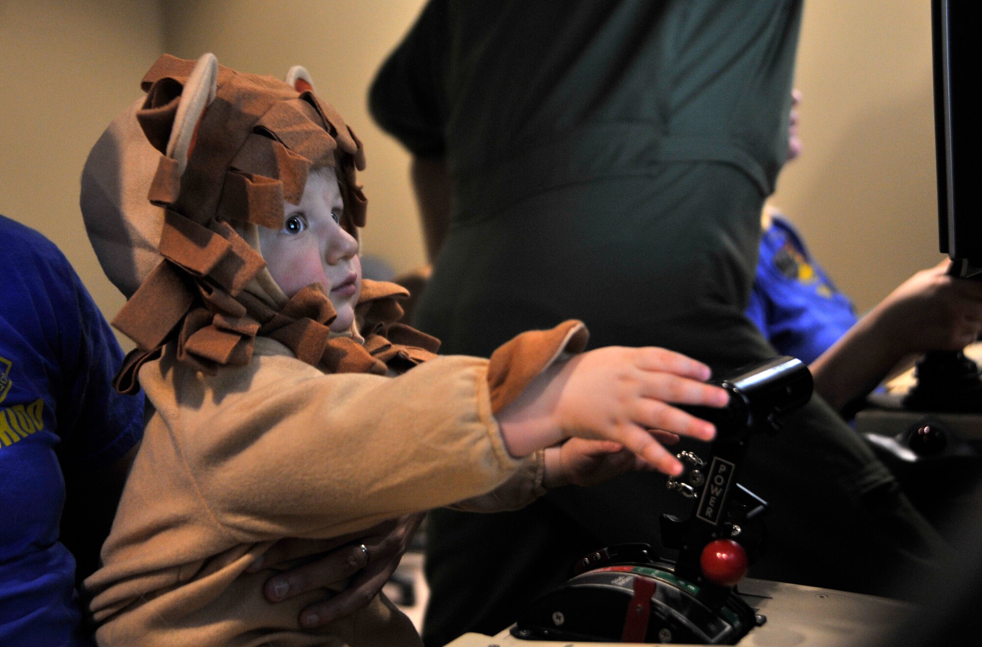 Nicholas Von Almen, 1, son of Capt. Christopher Von Almen, 432nd Operations Support Squadron flight commander, sits in a simulated ground control station during the first Team Creech Children’s Halloween Party Oct. 25, 2014, on Creech Air Force Base, Nevada. The event gave children the opportunity for a day of fun with other families and helped showcase what their parents do on a daily basis. (U.S. Air Force photo by Airman 1st Class Christian Clausen/Released)