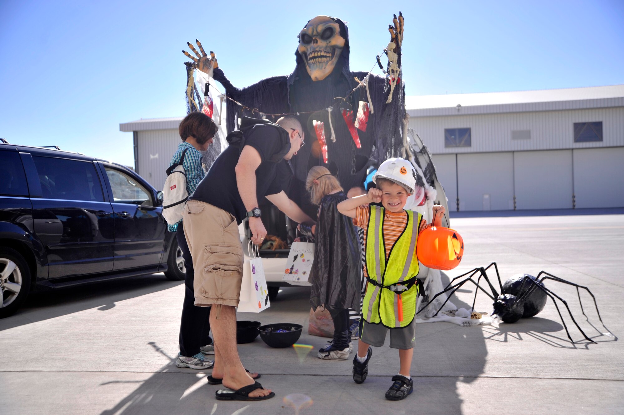Christopher, 5, son of Capt. Scott, 867th Reconnaissance Squadron, poses for a picture during the trunk-or-treat event during the first Team Creech Children’s Halloween Party Oct. 25, 2014, on Creech Air Force Base, Nevada. Activities included face painting, family photos, ring toss, ping pong, treat walk, book reading, and many more. The Fire Department also provided a fire truck for the children to sit in and explore. (U.S. Air Force photo by Airman 1st Class Christian Clausen/Released)