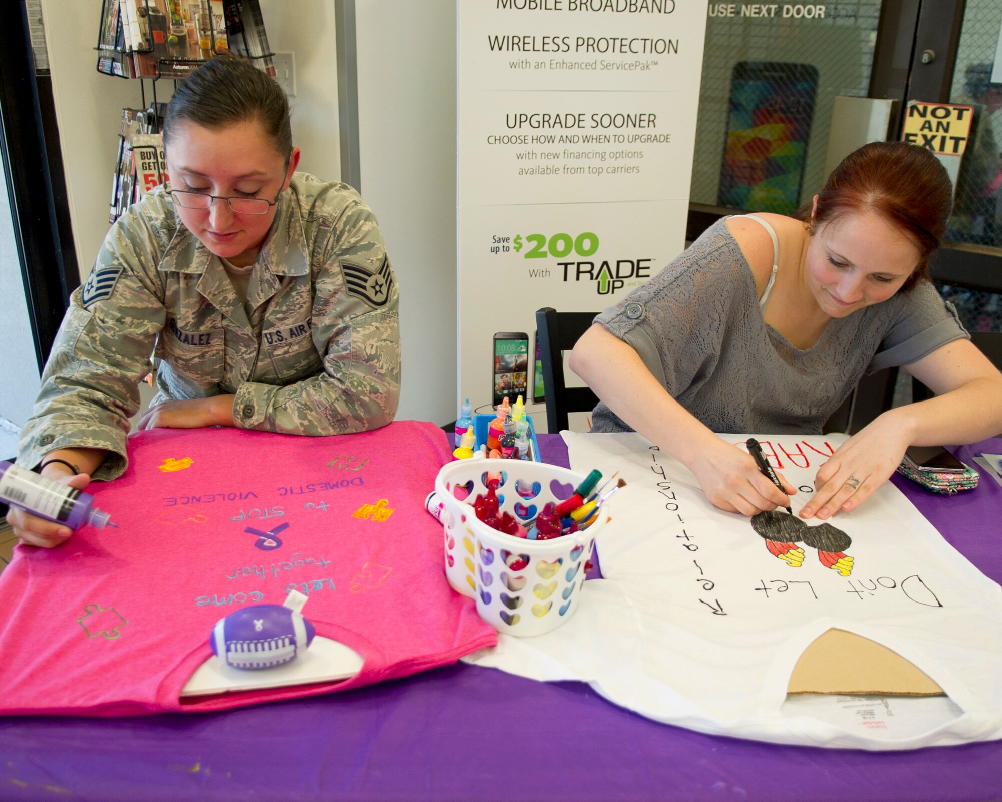 Staff Sgt. Estella Gonzalez, 325th Logistics Readiness Squadron material management technician, and Senior Airman Jennifer Jobe, 325th Maintenance Squadron munition controller, design display t-shirts for domestic violence awareness month Oct. 21 on Tyndall AFB, Fla. The shirts will serve as a reminder to people that domestic violence is a serious issue that affects everyone directly and indirectly. (U.S. Air Force photo by Airman 1st Class Ty-Rico Lea)