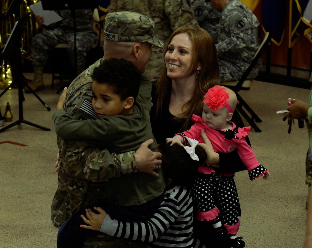 U.S. Army Sgt. John Kennerson, 53rd Transportation Battalion (Movement Control), 612th Movement Control Team noncommissioned officer, greets his family during a redeployment ceremony at Fort Eustis, Va., Oct. 28, 2014. The unit deployed to Afghanistan in support of Operation Enduring Freedom, where they helped facilitate cargo transportation and other logistics missions. (U.S. Air Forcce photo by Staff Sgt. Teresa Cleveland/Released)