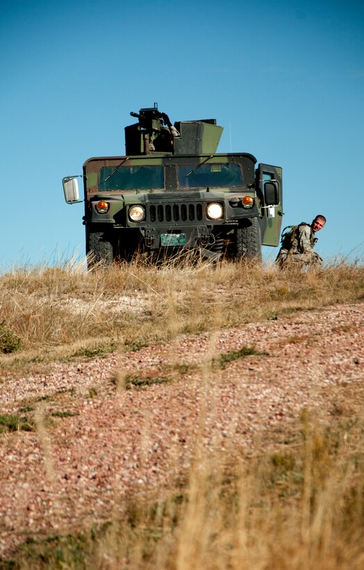 A team of 741st Missile Security Forces Squadron defenders from Malmstrom Air Force Base, Mont., perch atop a hillcrest at Camp Guernsey, Wyo., to provide security to a site of a simulated nuclear convoy attack during a training exercise Oct. 17, 2014. The exercise was the culmination of a week of training, the Nuclear Convoy Course, intended to hone convoy response force skills. (U.S. Air Force photo by Senior Airman Jason Wiese)