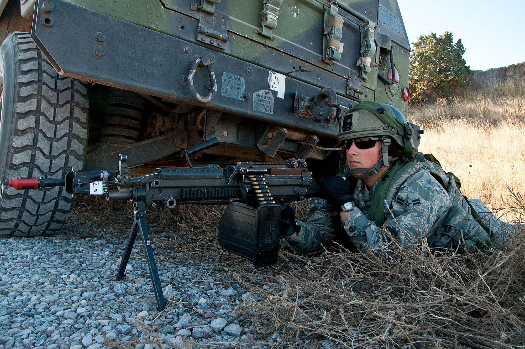 Airman 1st Class Kristen Warren, 741st Missile Security Forces Squadron from Malmstrom Air Force Base, Mont., wields an M-249 during a training exercise at Camp Guernsey, Wyo., Oct. 17, 2014. The machine gun was loaded with blanks to prevent harm to others taking part in the exercise. (U.S. Air Force photo by Senior Airman Jason Wiese)