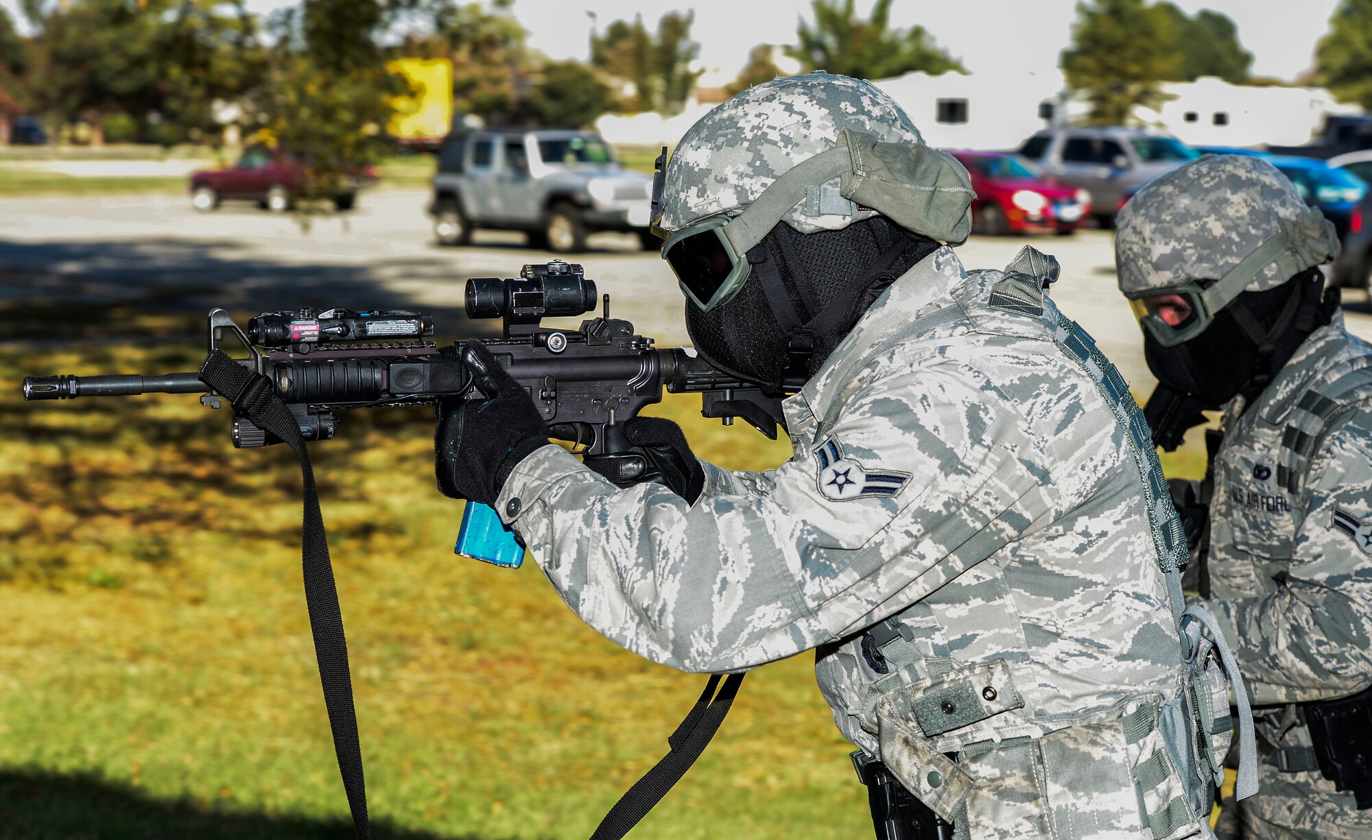 A U.S. Air Force Airman assigned to the 633rd Security Forces Squadron prepares to enter a building during active shooter training at Langley Air Force Base, Va., Oct. 28, 2014. During the training, Airmen used simulation rounds in their M-4 Rifle and M-9 Pistols in order to make the scenario more realistic.   (U.S. Air Force photo by Senior Airman Kayla Newman/Released) 