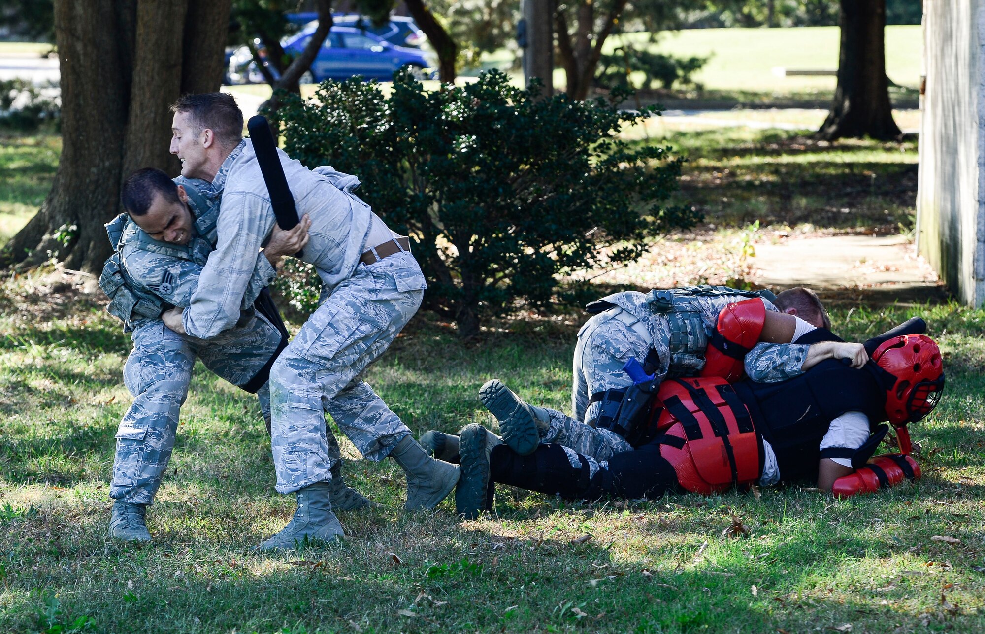 U.S. Air Force Airmen assigned to the 633rd Security Forces Squadron practice restraining threatening individuals during training at Langley Air Force Base, Va., Oct. 28, 2014. SFS Airmen conducted foot pursuit training as well as active shooter training to test their abilities and knowledge on how to successfully end a dangerous situation.  (U.S. Air Force photo by Senior Airman Kayla Newman/Released) 