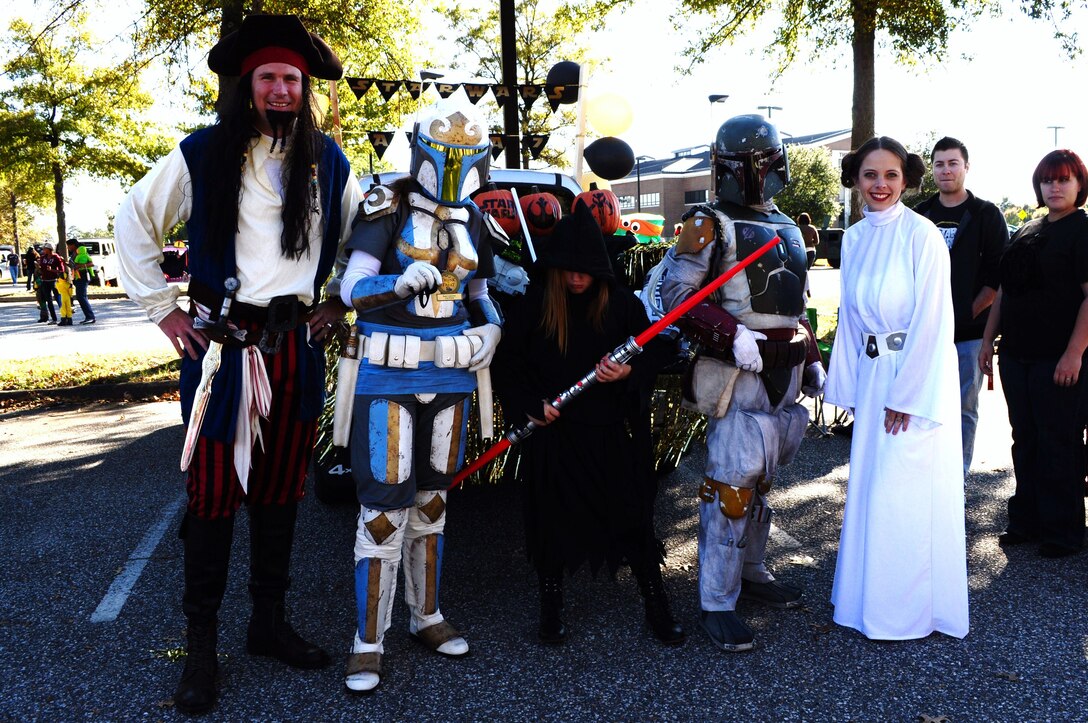 U.S. Air Force Lt. Col. Gregory Beaulieu, 633rd Force Support Squadron commander, left, congratulates members of the Air Combat Command A7, Installations and Missions Support Directorate, on winning second place in the Trunk-or-Treat costume contest at Langley Air Force Base, Va., Oct. 25, 2014. During the event, Joint Base Langley-Eustis community members trick-or-treated from parked car to parked car as an alternative to going house-to-house. (Courtesy photo)