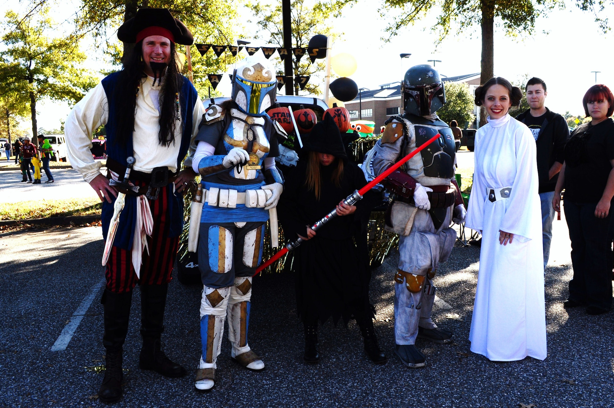 U.S. Air Force Lt. Col. Gregory Beaulieu, 633rd Force Support Squadron commander, left, congratulates members of the Air Combat Command A7, Installations and Missions Support Directorate, on winning second place in the Trunk-or-Treat costume contest at Langley Air Force Base, Va., Oct. 25, 2014. During the event, Joint Base Langley-Eustis community members trick-or-treated from parked car to parked car as an alternative to going house-to-house. (Courtesy photo)