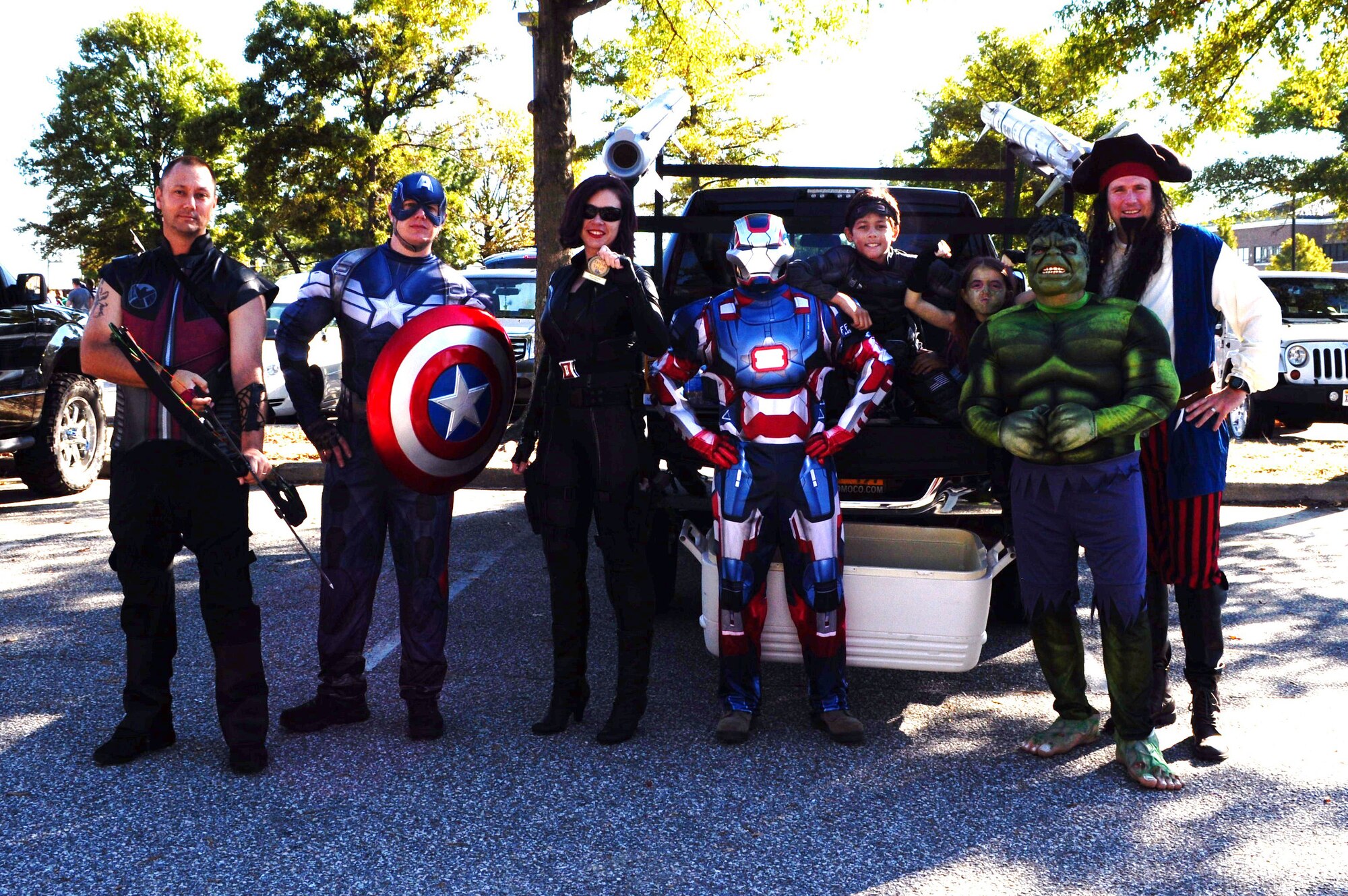 U.S. Air Force Lt. Col. Gregory Beaulieu, 633rd Force Support Squadron commander, far right, congratulates members of the Air Combat Command A4, Maintenance and Logistics Directorate, on winning third place in the Trunk-or-Treat costume contest at Langley Air Force Base, Va., Oct. 25, 2014. First, second and third place costume winners received medals. (Courtesy photo)