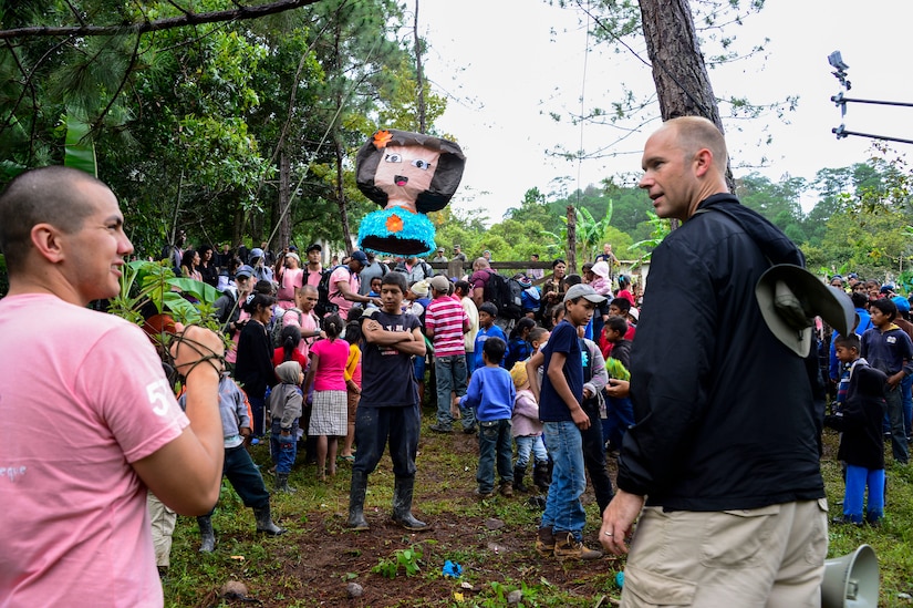 U.S. Army Sgt. Joshua Smith, Joint Task Force-Bravo chaplain assistant, and U.S. Air Force Capt. Samuel McClellan, Joint Task Force-Bravo command chaplain, prepare a piñata for the children in Potrerillos, Siguatepeque, Honduras, Oct. 25, 2014.  As part of the 57th Chapel Hike, more than 130 members assigned to Joint Task Force-Bravo laced up their hiking boots and trekked almost four miles up a mountain to help deliver over 3,500-pounds of donated dry goods to villagers in need. (U.S. Air Force photo/Tech. Sgt. Heather Redman)