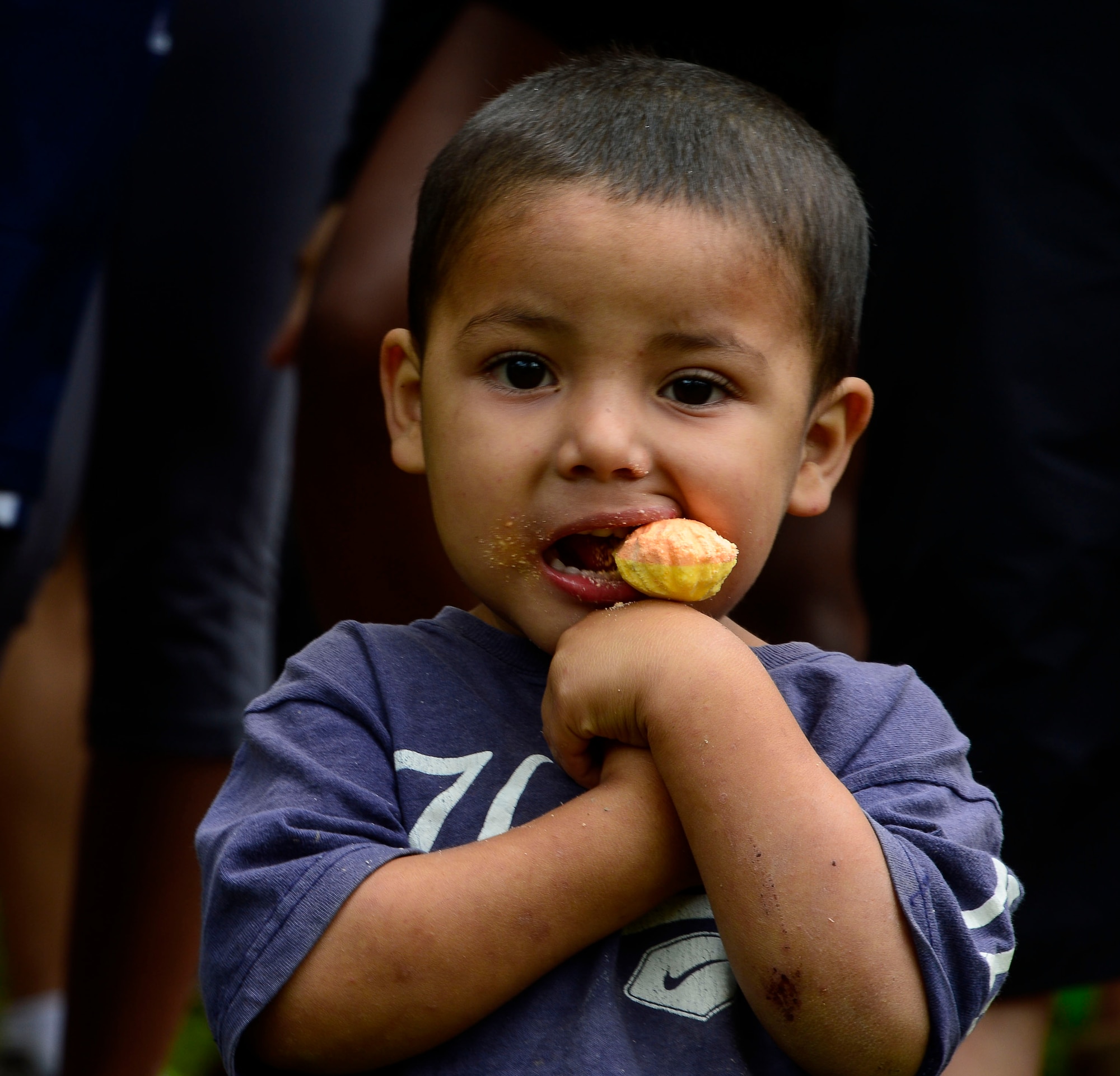 A young boy chews on a lollipop given to him by one of the Chapel Hike volunteers in Potrerillos, Siguatepeque, Honduras, Oct. 25, 2014.  As part of the 57th Chapel Hike, more than 130 members assigned to Joint Task Force-Bravo laced up their hiking boots and trekked almost four miles up a mountain to help deliver over 3,500-pounds of donated dry goods to villagers in need. (U.S. Air Force photo/Tech. Sgt. Heather Redman)