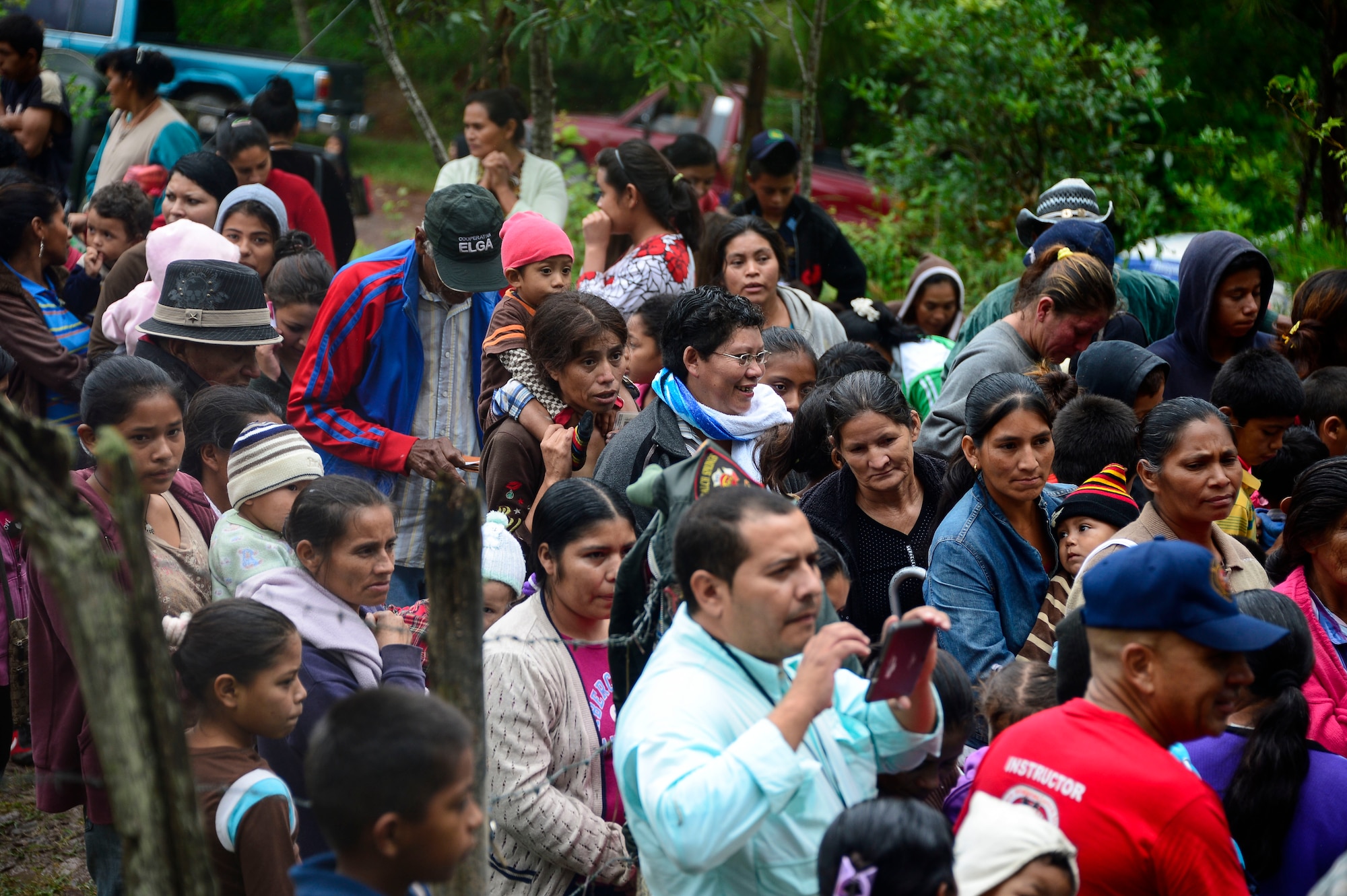 Villagers from Potrerillos, Siguatepeque, Honduras, line up to receive bags of food from members of Joint Task Force-Bravo, Oct. 25, 2014.  As part of the 57th Chapel Hike, more than130 members assigned to Joint Task Force-Bravo laced up their hiking boots and trekked almost four miles up a mountain to help deliver over 3,500-pounds of donated dry goods to villagers in need. (U.S. Air Force photo/Tech. Sgt. Heather Redman)