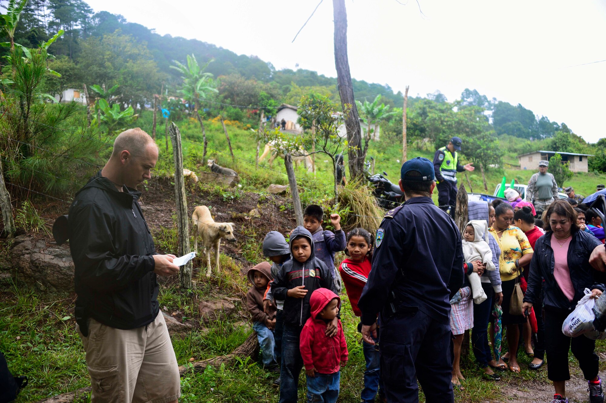 U.S. Air Force Capt. Samuel McClellan, Joint Task Force-Bravo command chaplain, gives the invocation before handing out bags of donated food to villagers in Potrerillos, Siguatepeque, Honduras, Oct. 25, 2014.  As part of the 57th Chapel Hike, more than 130 members assigned to Joint Task Force-Bravo laced up their hiking boots and trekked almost four miles up a mountain to help deliver over 3,500-pounds of donated dry goods to villagers in need. (U.S. Air Force photo/Tech. Sgt. Heather Redman)