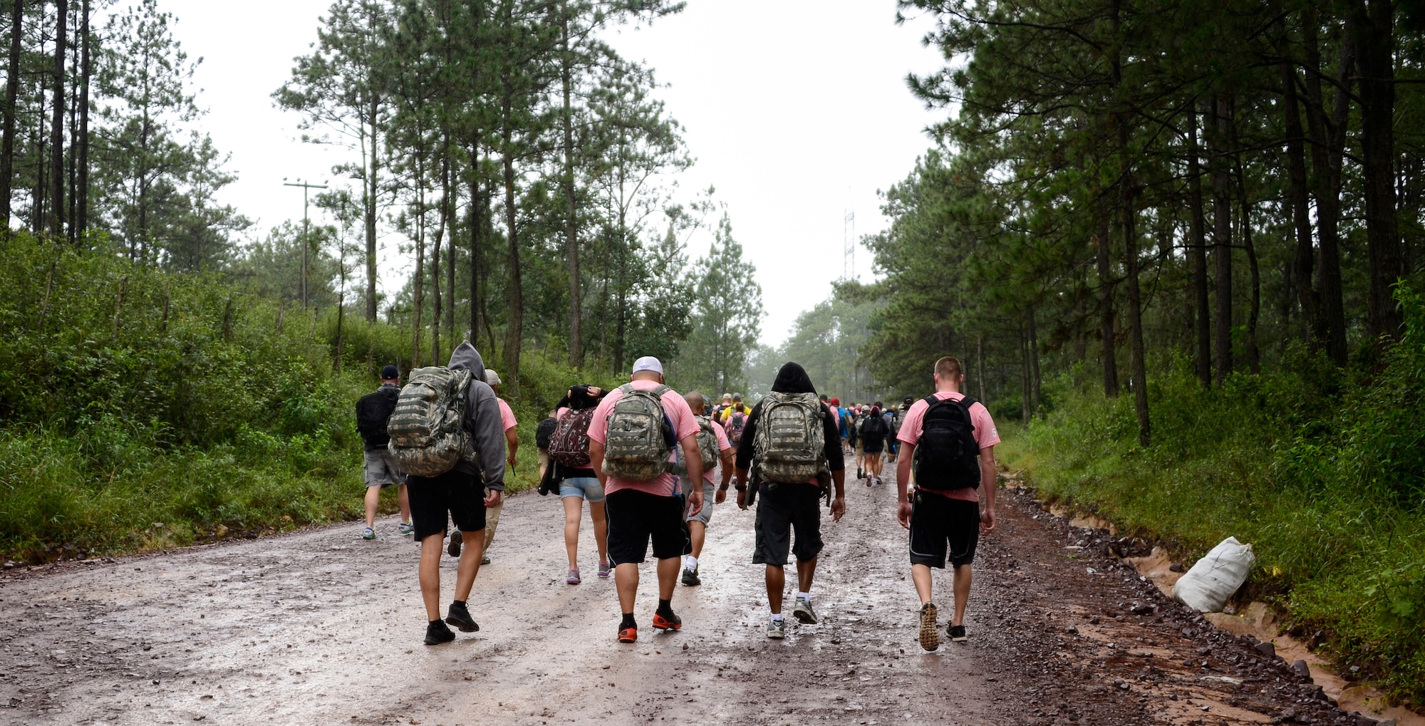 Volunteers carry 35-pounds of food in backpacks to villagers in Potrerillos, Siguatepeque, Honduras, Oct. 25, 2014.  As part of the 57th Chapel Hike, more than 130 members assigned to Joint Task Force-Bravo laced up their hiking boots and trekked almost four miles up a mountain to help deliver over 3,500-pounds of donated dry goods to villagers in need. (U.S. Air Force photo/Tech. Sgt. Heather Redman)