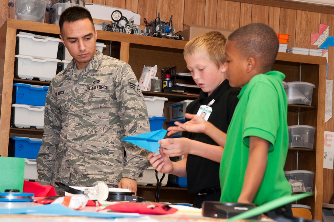 A U.S. Air Force Airman from Barksdale Air Force Base, La. helps a couple of Rusheon Middle School students with an investigation in aerodynamics during the STARBASE 2.0 afterschool program, Bossier City, La., Oct. 23, 2014. STARBASE Louisiana is a program sponsored by the 307th Bomb Wing, that encourages students to explore science, technology, engineering, and mathematics. (U.S. Air Force photo by Master Sgt. Dachelle Melville/Released)