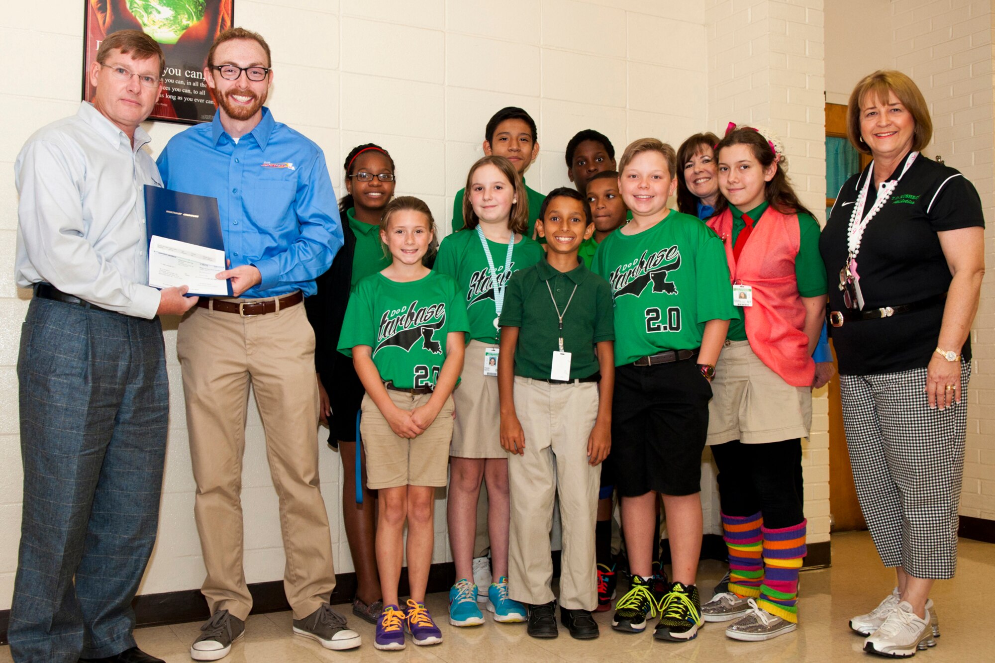 Retired U.S. Air Force Col. Andy Thompson, Sector Lead Executive of the Air Force Global Strike Command for Northrup Grumman, presents STARBASE Louisiana a check for $3,000, Oct. 23, 2014, to support their 2.0 after school. STARBASE Louisiana, located on Barksdale Air Force Base, La., is a program, sponsored by the 307th Bomb Wing, which provides local schools with an environment that actively engages students in the exploration of science, technology, engineering, and mathematics. (U.S. Air Force photo by Master Sgt. Dachelle Melville/Released)