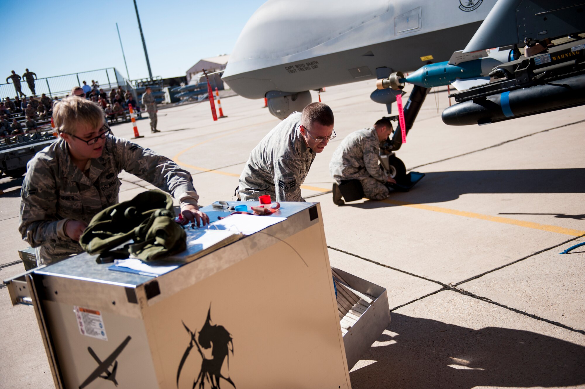 The 49th Aircraft Maintenance Squadron MQ-9 Reaper weapons load crew, works to load a GBU-12 Paveway bomb to the MQ-9 at Holloman Air Force Base, N.M., Oct. 24. The German Tornado, F-16 Fighting Falcon and MQ-9 were all pitted against each other to see who could load weapons the most efficiently and with the least amount of procedural errors. (U.S. Air Force photo by Senior Airman Daniel Liddicoet/Released)