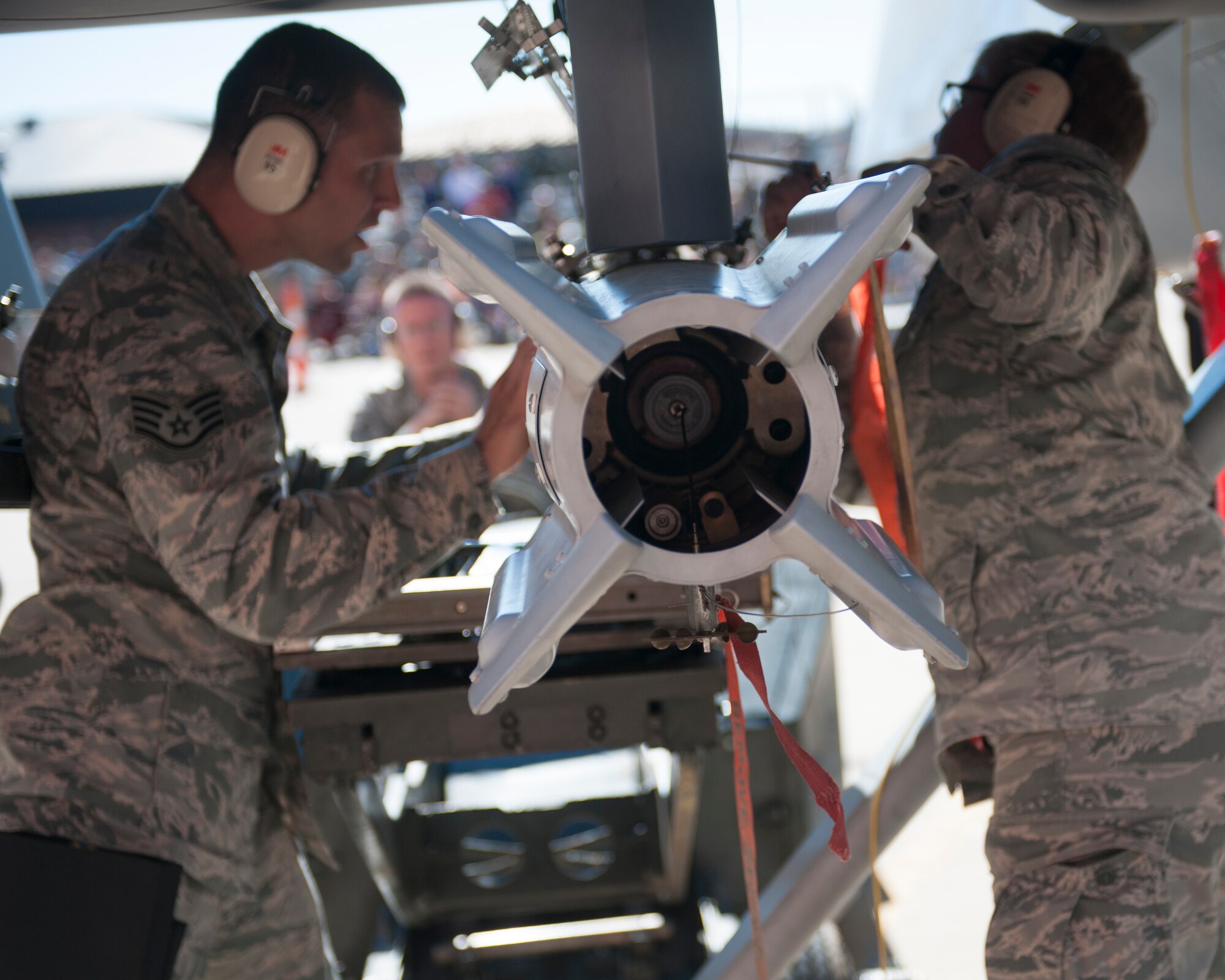The 49th Aircraft Maintenance Squadron MQ-9 Reaper weapons load crew aligns a GBU-12 Paveway bomb to the MQ-9 at Holloman Air Force Base, N.M., Oct. 24. Load crew competitions are held on a quarterly basis and are used to help build morale through friendly competition. (U.S. Air Force photo by Senior Airman Daniel Liddicoet/Released)