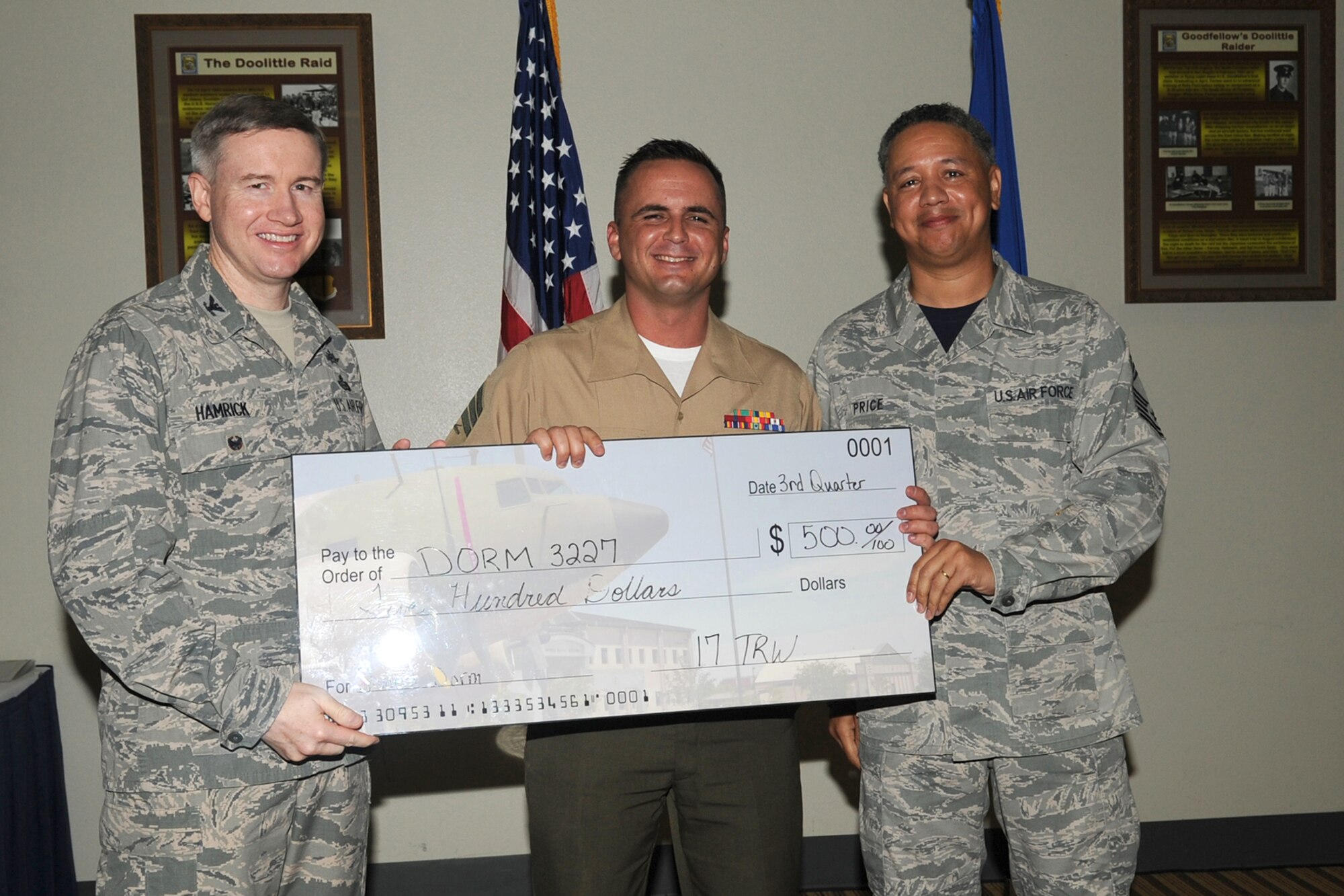GOODFELLOW AIR FORCE BASE, Texas - Col. Terry J. Hamrick Jr., 17th Training Wing Vice Commander, and Chief Master Sgt. William E. Price, 17th Communications Squadron superintendent, present Marine Corps Sgt. Brian M. Mos, Marine Corps Detachment, with the Team Goodfellow Student Dormitory of the Quarter award during the wing quarterly awards ceremony at the Event Center Oct. 24. (U.S. Air Force photo/ Staff Sgt. Laura R. McFarlane)