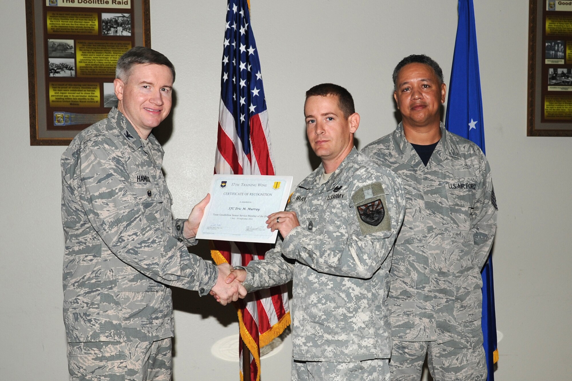 GOODFELLOW AIR FORCE BASE, Texas - Col. Terry J. Hamrick Jr., 17th Training Wing Vice Commander, and Chief Master Sgt. William E. Price, 17th Communications Squadron superintendent, present Army Sgt. 1st Class Eric M. Murray, 344th Military Intelligence Battalion, with the Team Goodfellow Senior Servicemember of the Quarter award during the wing quarterly awards ceremony at the Event Center Oct. 24. (U.S. Air Force photo/ Staff Sgt. Laura R. McFarlane)