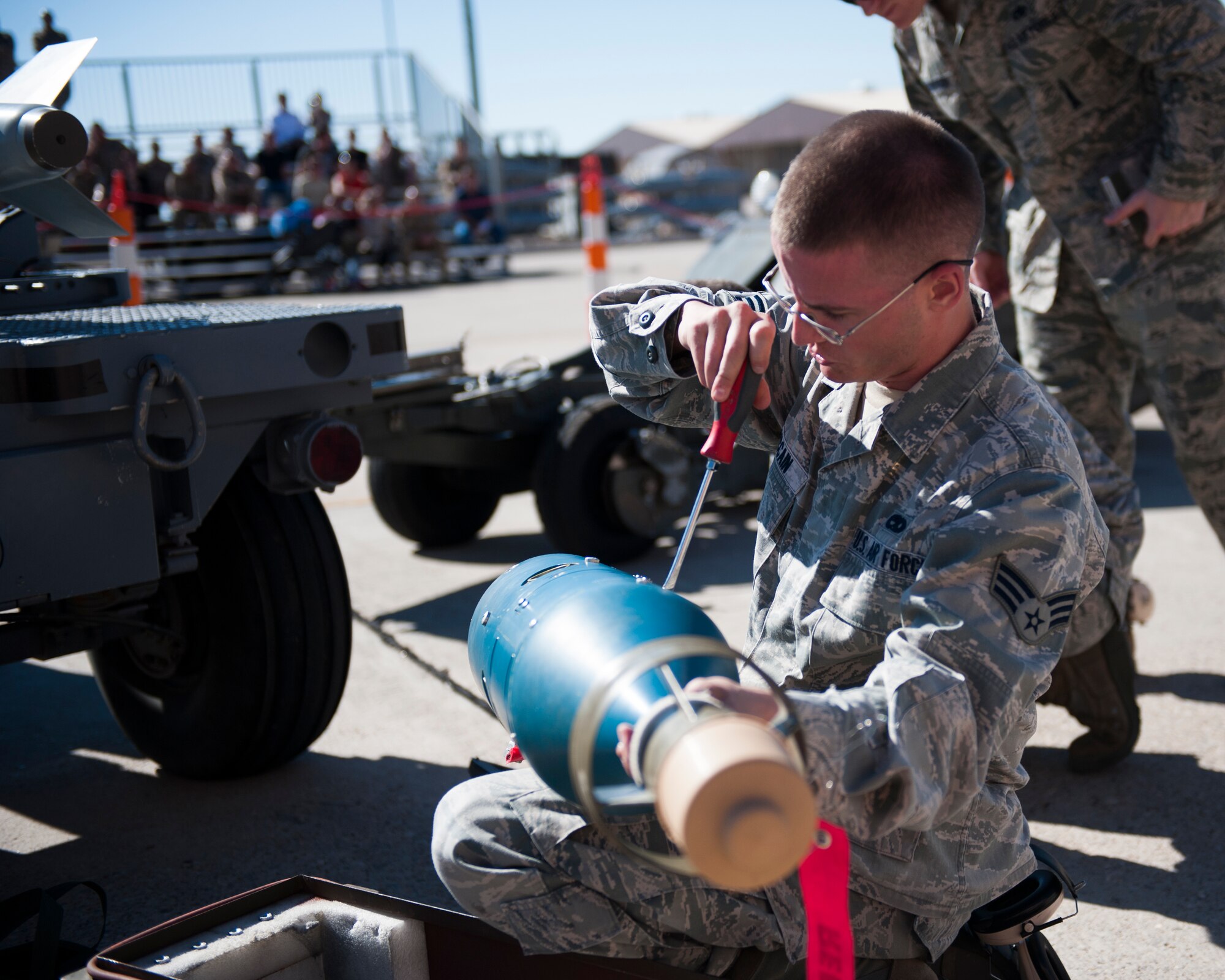Senior Airman Sammy McCain, 49th Aircraft Maintenance Squadron MQ-9 Reaper weapons load crew member, prepares a GBU-12 Paveway bomb for an MQ-9 at Holloman Air Force Base, N.M., Oct. 24. The German Tornado, F-16 Fighting Falcon and MQ-9 Reaper were all pitted against each other to see who could load weapons the most efficiently and with the least amount of procedural errors. (U.S. Air Force photo by Senior Airman Daniel Liddicoet/Released)