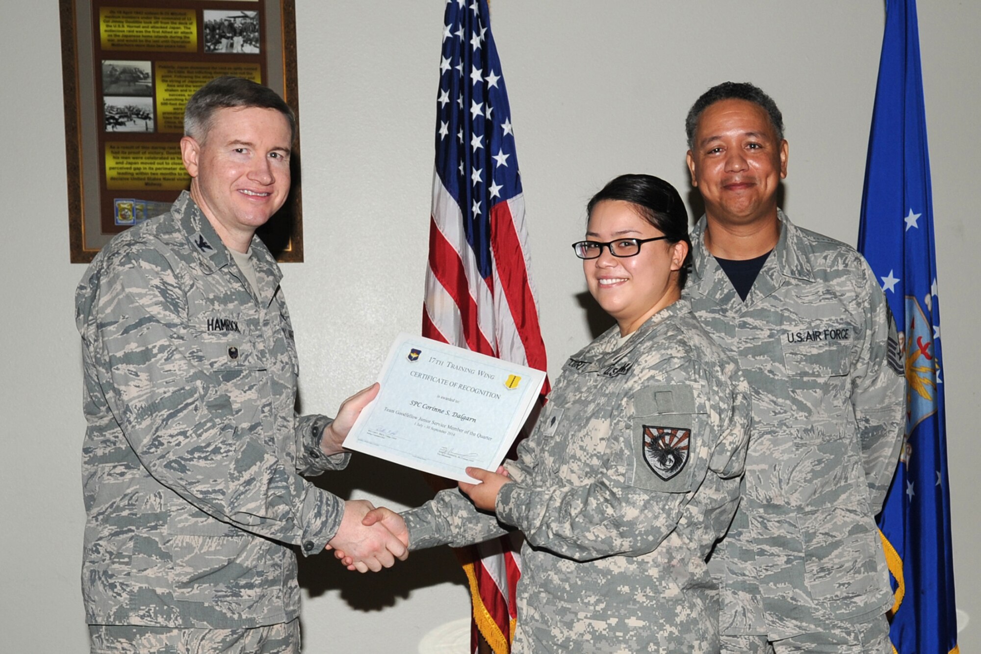 GOODFELLOW AIR FORCE BASE, Texas - Col. Terry J. Hamrick Jr., 17th Training Wing Vice Commander, and Chief Master Sgt. William E. Price, 17th Communications Squadron superintendent, present Army Spc. Corinne S. Dalgarn, 344th Military Intelligence Battalion, with the Team Goodfellow Junior Servicemember of the Quarter award during the wing quarterly awards ceremony at the Event Center Oct. 24. (U.S. Air Force photo/ Staff Sgt. Laura R. McFarlane)
