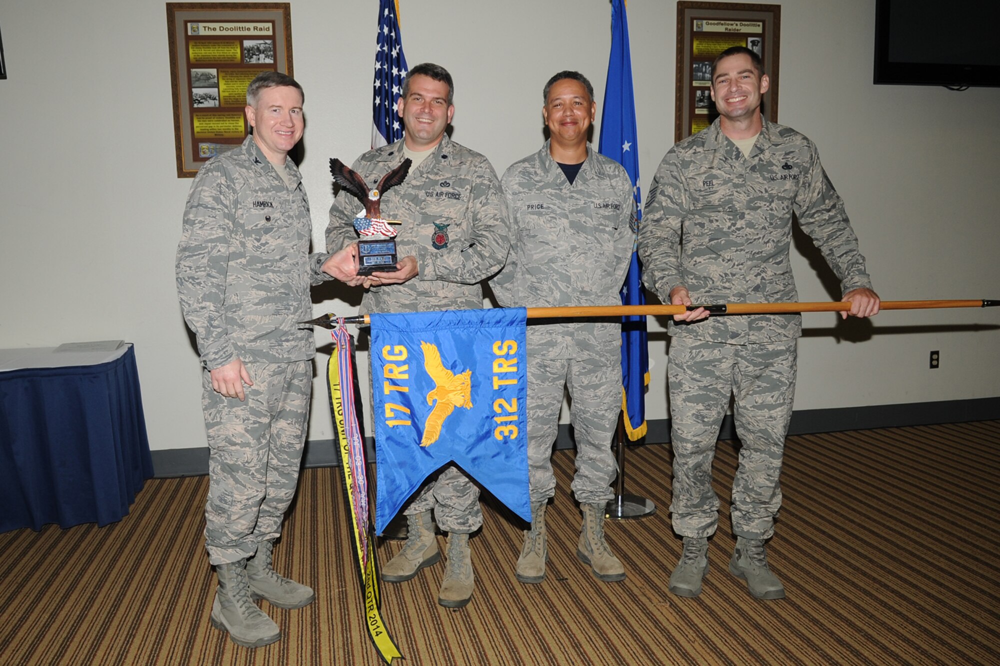 GOODFELLOW AIR FORCE BASE, Texas - Col. Terry J. Hamrick Jr., 17th Training Wing Vice Commander, and Chief Master Sgt. William E. Price, 17th Communications Squadron superintendent, present Lt. Col. Derek R. Ferland, 312th Training Squadron Commander, with the 17th Training Wing Unit of the Quarter award during the wing quarterly awards ceremony at the Event Center Oct. 24. The 312th TRS also won Team Goodfellow Unit of the Quarter. (U.S. Air Force photo/ Staff Sgt. Laura R. McFarlane)