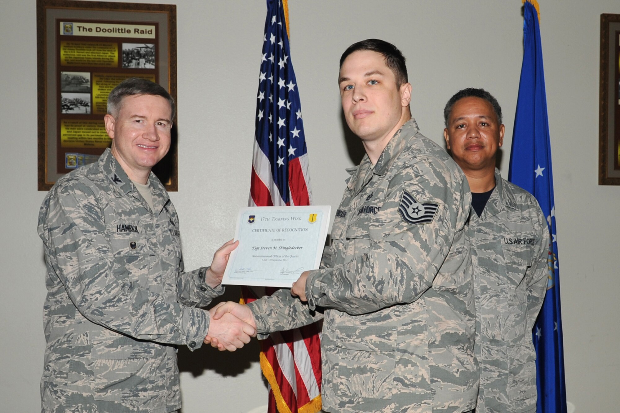 GOODFELLOW AIR FORCE BASE, Texas - Col. Terry J. Hamrick Jr., 17th Training Wing Vice Commander, and Chief Master Sgt. William E. Price, 17th Communications Squadron superintendent, present the 17th Training Wing NCO of the Quarter award to Tech. Sgt. Steven M. Shingledecker, 17th Training Group, during the wing quarterly awards ceremony at the Event Center Oct. 24. Shingledecker also won Team Goodfellow NCO of the Quarter. (U.S. Air Force photo/Staff Sgt. Laura R. McFarlane)