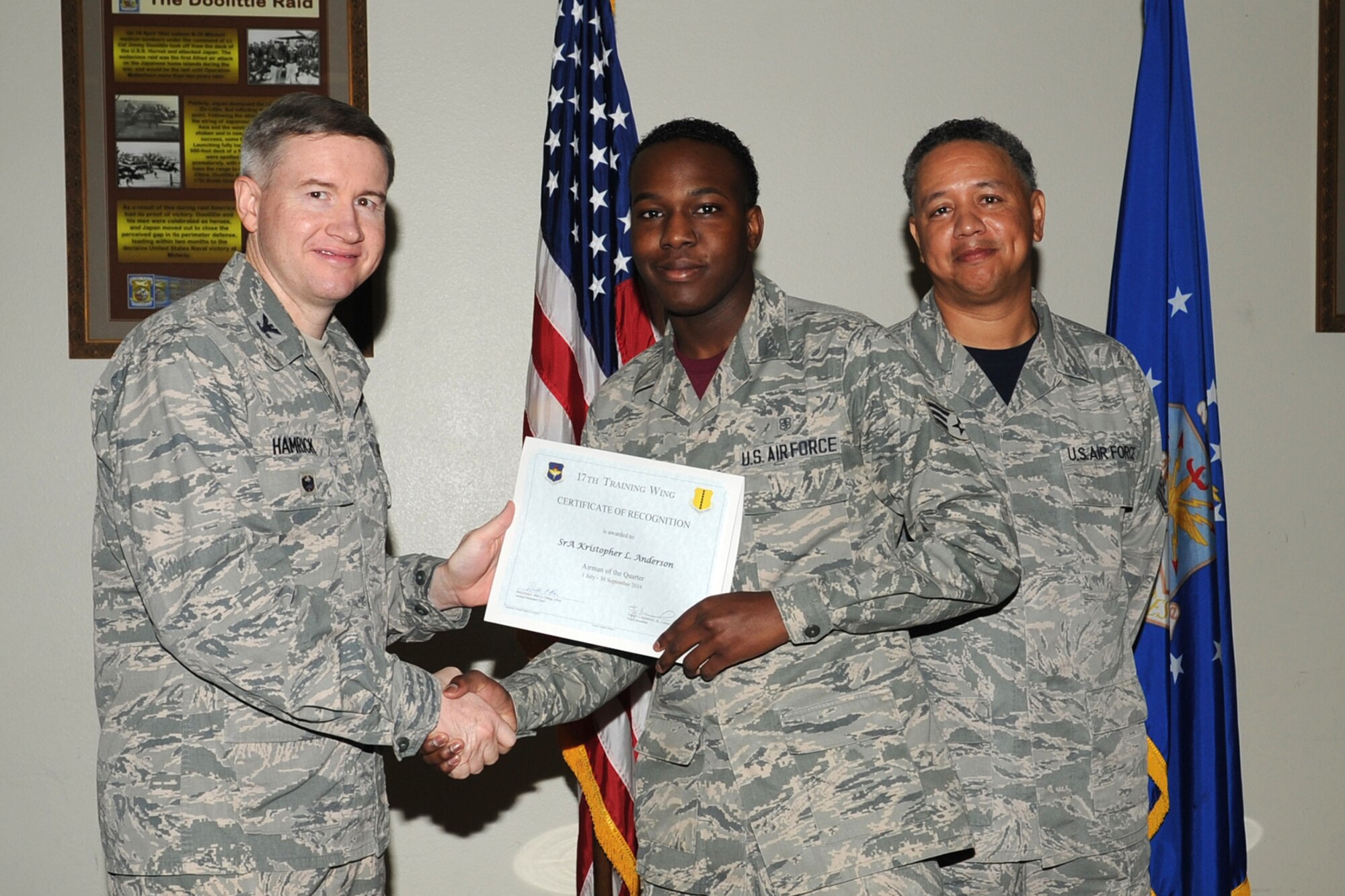 GOODFELLOW AIR FORCE BASE, Texas - Col. Terry J. Hamrick Jr., 17th Training Wing Vice Commander, and Chief Master Sgt. William E. Price, 17th Communications Squadron superintendent, present the 17th Training Wing Airman of the Quarter award to Senior Airman Kristopher L. Anderson, 17th Medical Operations Squadron, during the wing quarterly awards ceremony at the Event Center Oct. 24. (U.S. Air Force photo/Staff Sgt. Laura R. McFarlane)
