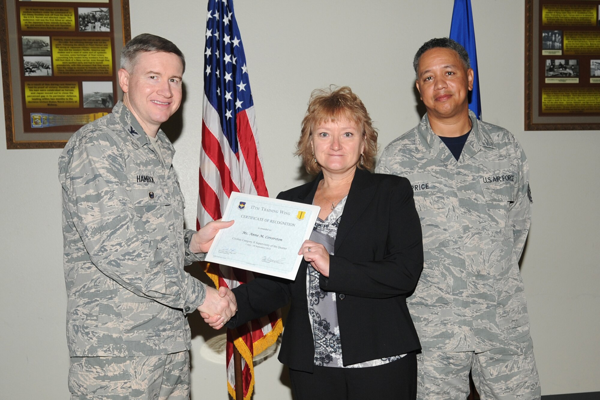 GOODFELLOW AIR FORCE BASE, Texas - Col. Terry J. Hamrick Jr., 17th Training Wing Vice Commander, and Chief Master Sgt. William E. Price, 17th Communications Squadron superintendent, present the 17th Training Wing Civilian Category II Supervisory of the Quarter award to Anne M. Coverston, 17th Civil Engineer Squadron, during the wing quarterly awards ceremony at the Event Center Oct. 24. (U.S. Air Force photo/ Staff Sgt. Laura R. McFarlane)