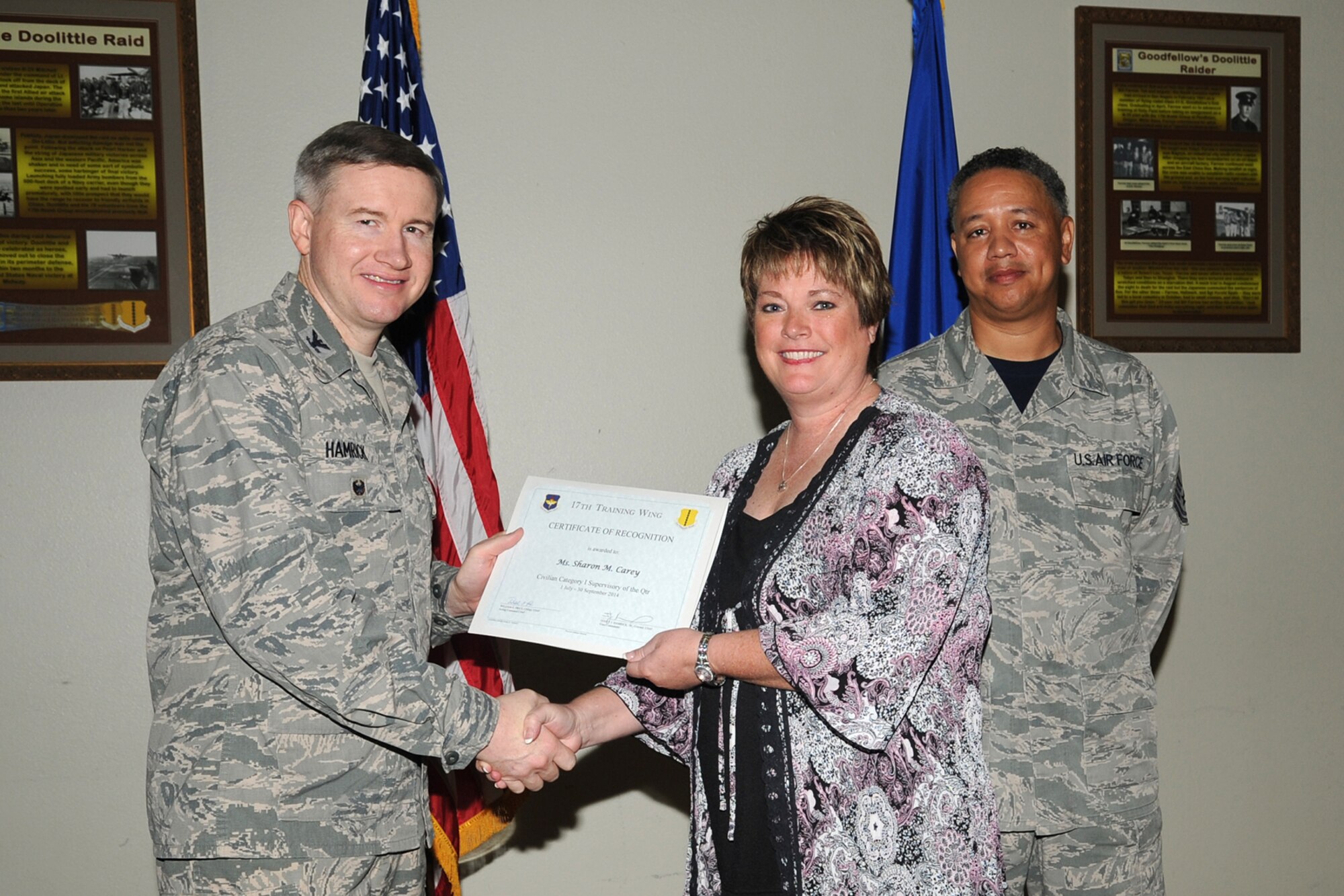 GOODFELLOW AIR FORCE BASE, Texas - Col. Terry J. Hamrick Jr., 17th Training Wing Vice Commander, and Chief Master Sgt. William E. Price, 17th Communications Squadron superintendent, present the 17th Training Wing Civilian Category I Supervisory of the Quarter award to Sharon M. Carey, 17th Civil Engineer Squadron, during the wing quarterly awards ceremony at the Event Center Oct. 24. (U.S. Air Force photo/Staff Sgt. Laura R. McFarlane)