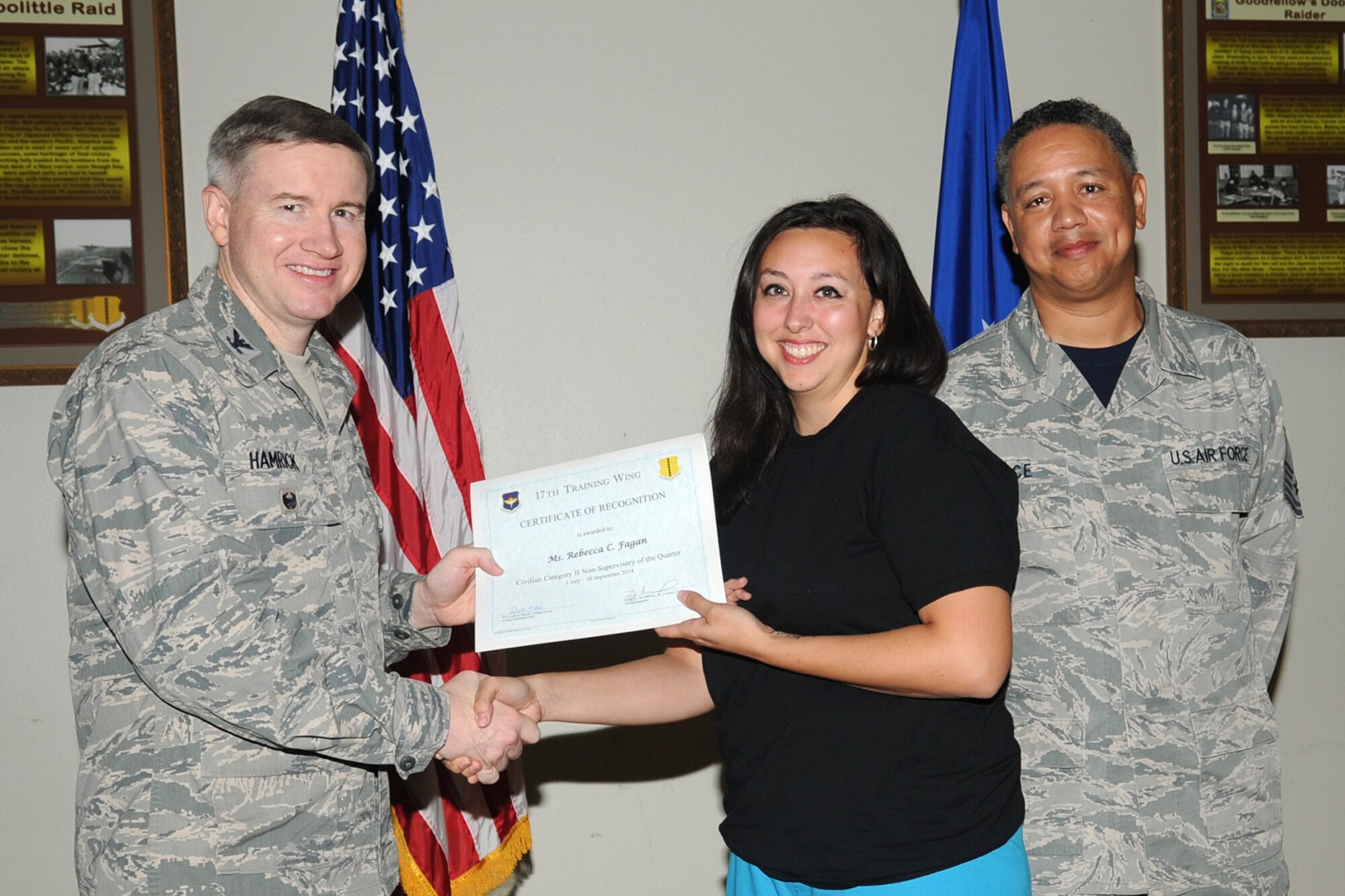 GOODFELLOW AIR FORCE BASE, Texas - Col. Terry J. Hamrick Jr., 17th Training Wing Vice Commander, and Chief Master Sgt. William E. Price, 17th Communications Squadron superintendent, present the 17th Training Wing Civilian Category II Non-Supervisory of the Quarter award to Rebecca C. Fagan, 17th Medical Operations Squadron, during the wing quarterly awards ceremony at the Event Center Oct. 24. Fagan also won Team Goodfellow Civilian Category II Non-Supervisory of the Quarter. (U.S. Air Force photo/Staff Sgt. Laura R. McFarlane)