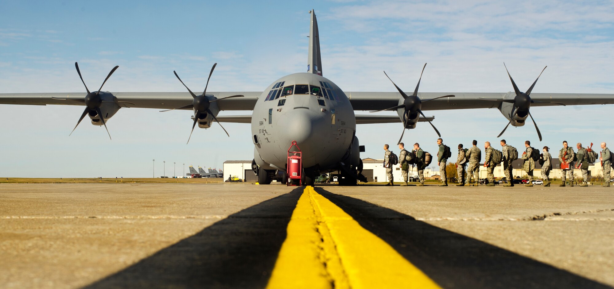 Airmen from the 2nd Bomb Wing, Barksdale Air Force Base, La., board a C-130 Hercules at Minot Air Force Base, N.D., Oct. 18, 2014. The flight is in support of Global Thunder 15, a field training and battle staff exercise designed to exercise all U. S. Strategic Command mission areas with primary emphasis on nuclear command, control and communications. (U.S. Air Force photo by Senior Airman Brittany Y. Bateman)