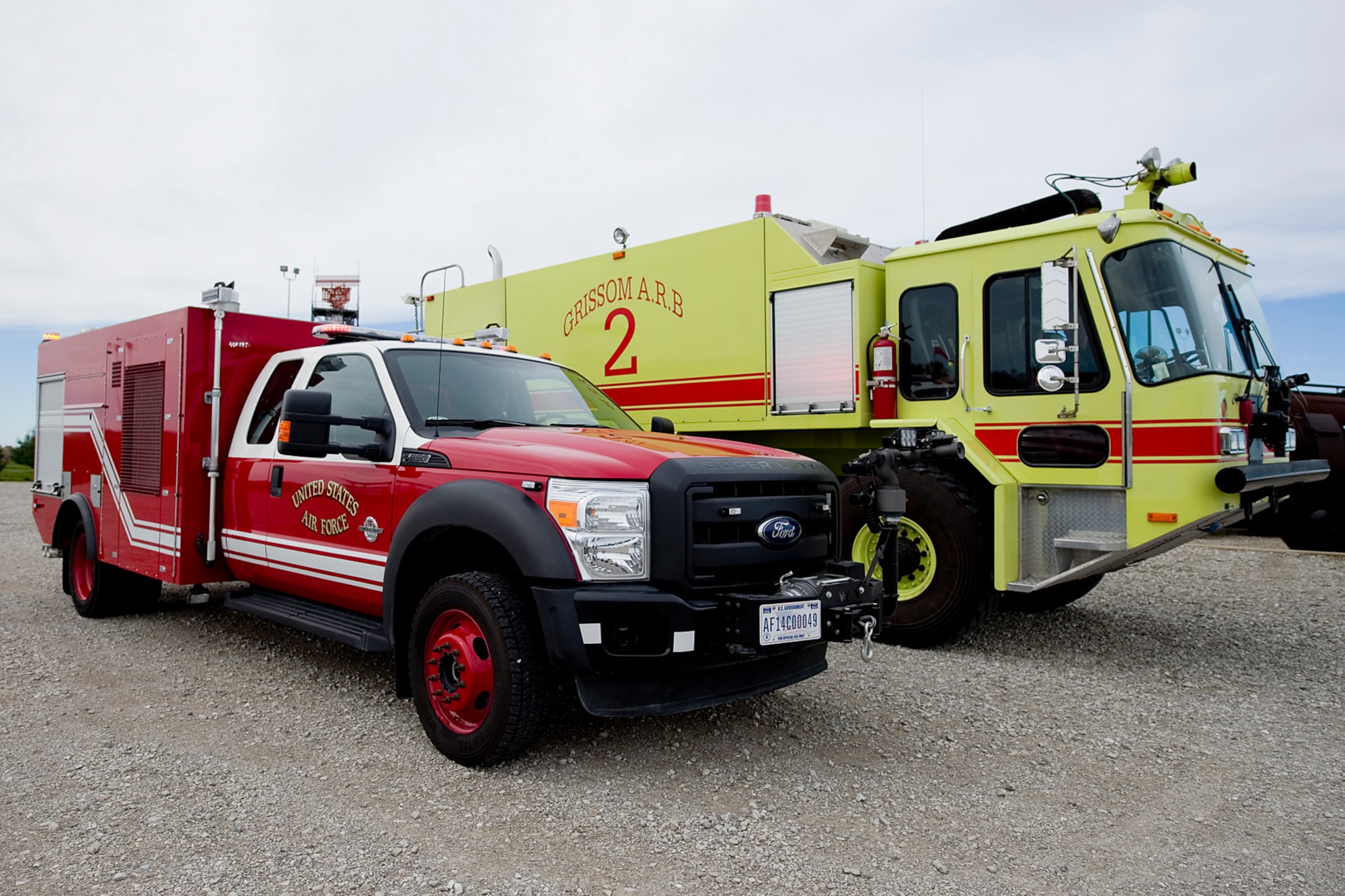 Grissom's newest vehicle, the P-34 rapid intervention vehicle is dwarfed by the base's P-23 aircraft fire rescue vehicle as they sit next to each other in the fire training area at Grissom Air Reserve Base, Ind., Oct. 28, 2014. The P-34 uses high pressure technology to enhance the base's firefighting capabilities. (U.S. Air Force photo/Tech. Sgt. Douglas Hays)