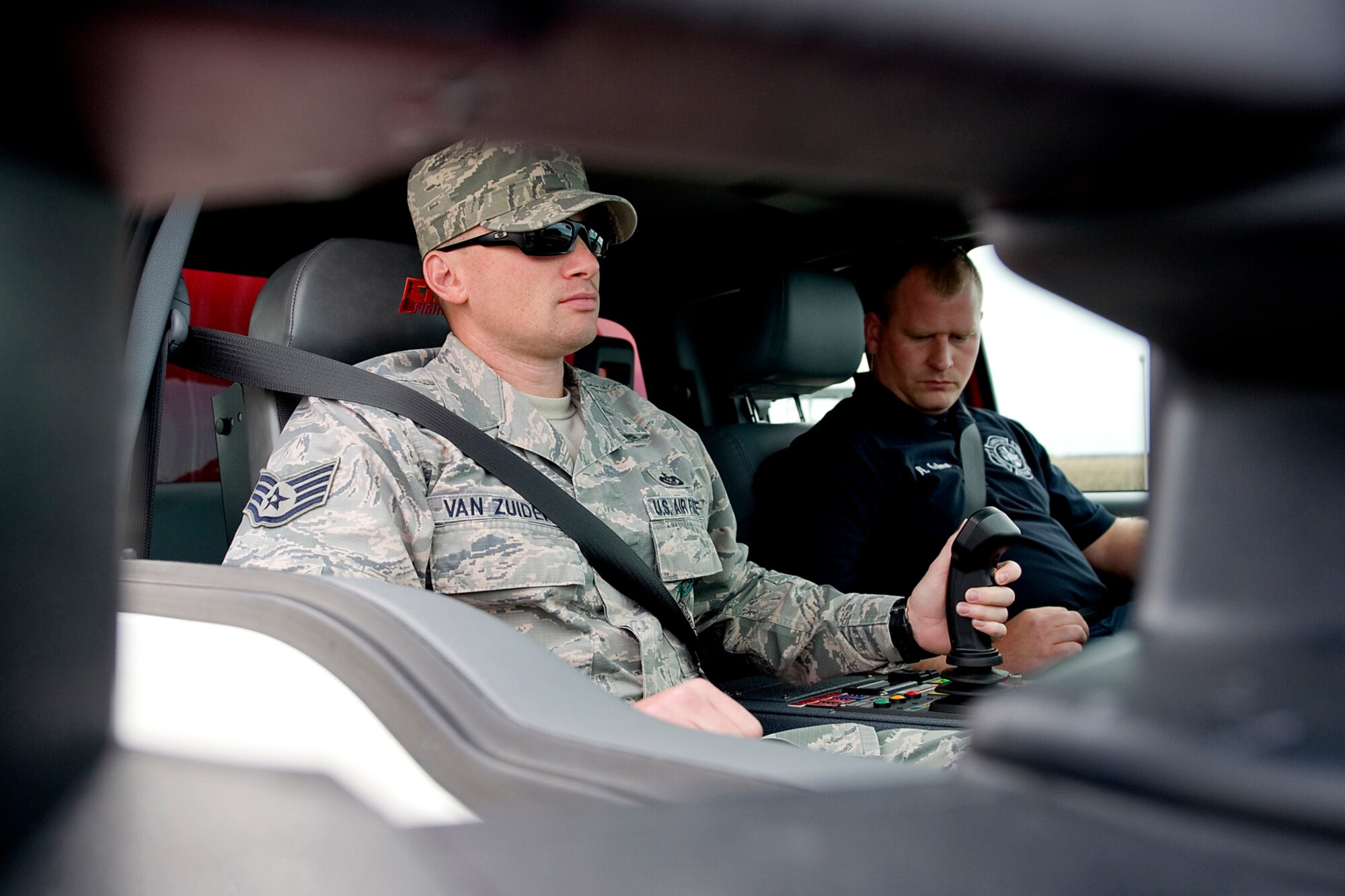 Staff Sgt. Joshua Van Zuiden, left, and Adam Osborn, both Grissom firefighters, use a new rapid intervention vehicle to fight a simulated aircraft fire at Grissom Air Reserve Base, Ind., Oct. 28, 2014. The truck, dubbed a P-34, uses high pressure technology to enhance the base's firefighting capabilities. (U.S. Air Force photo/Tech. Sgt. Douglas Hays)